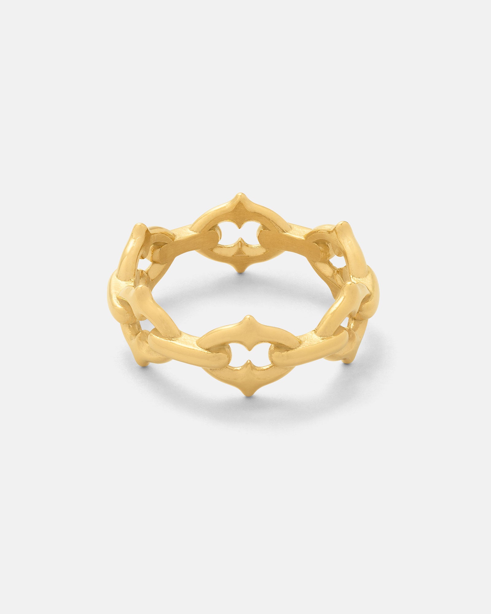 The Cathedral" Spiked Ring (Gold) features an intricate geometric cutout pattern forming a continuous band, showcased against a plain light grey background.