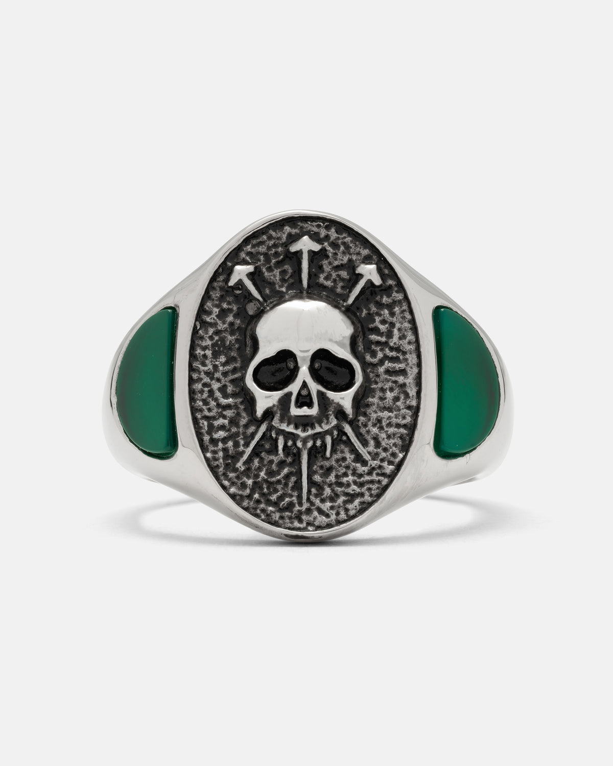 SARA_S X STATEMENT Condemned Signet Ring: a silver skull ring with an oval face featuring an engraved skull pierced by three arrows, flanked by inlaid green stones.
