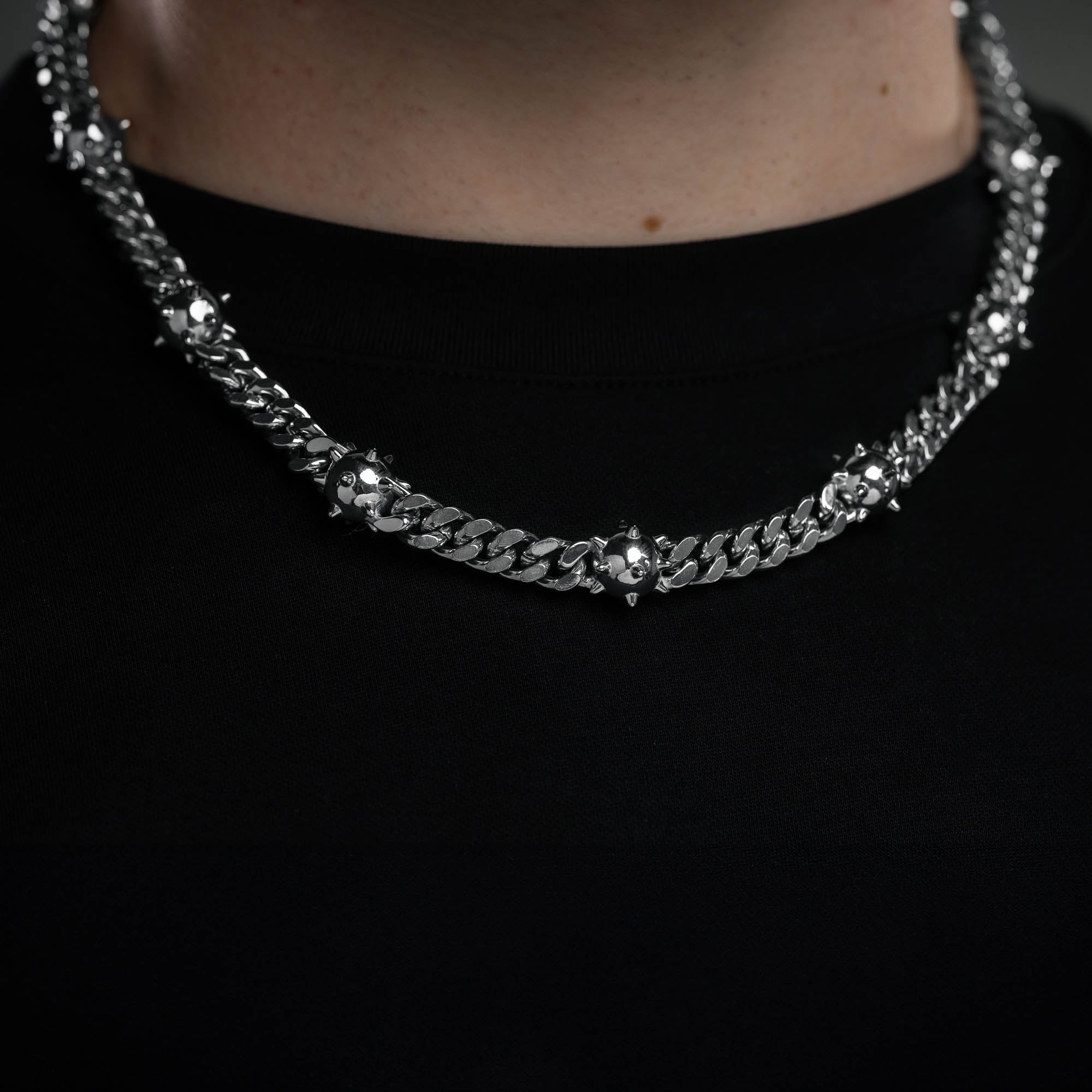 Spiked ball necklace chain on mens neck with black shirt