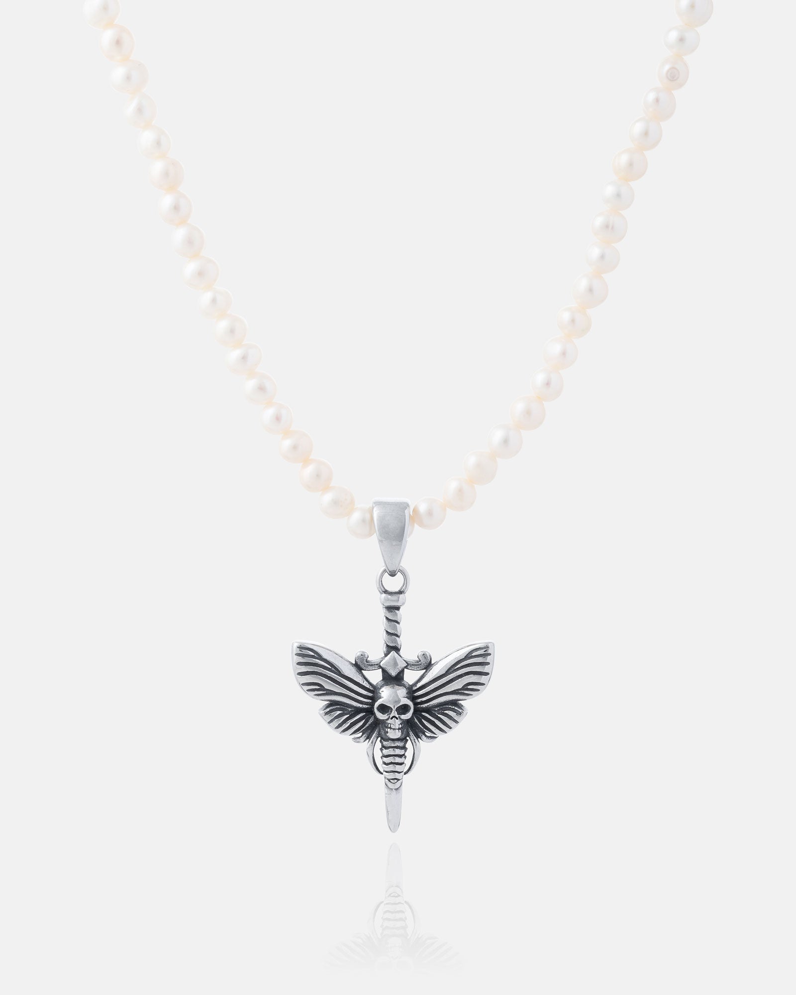 The Freshwater Pearl Necklace With Custom Pendant Choice is shown with a silver pendant featuring a sword, butterfly wings, and a central skull, displayed on a plain light background.