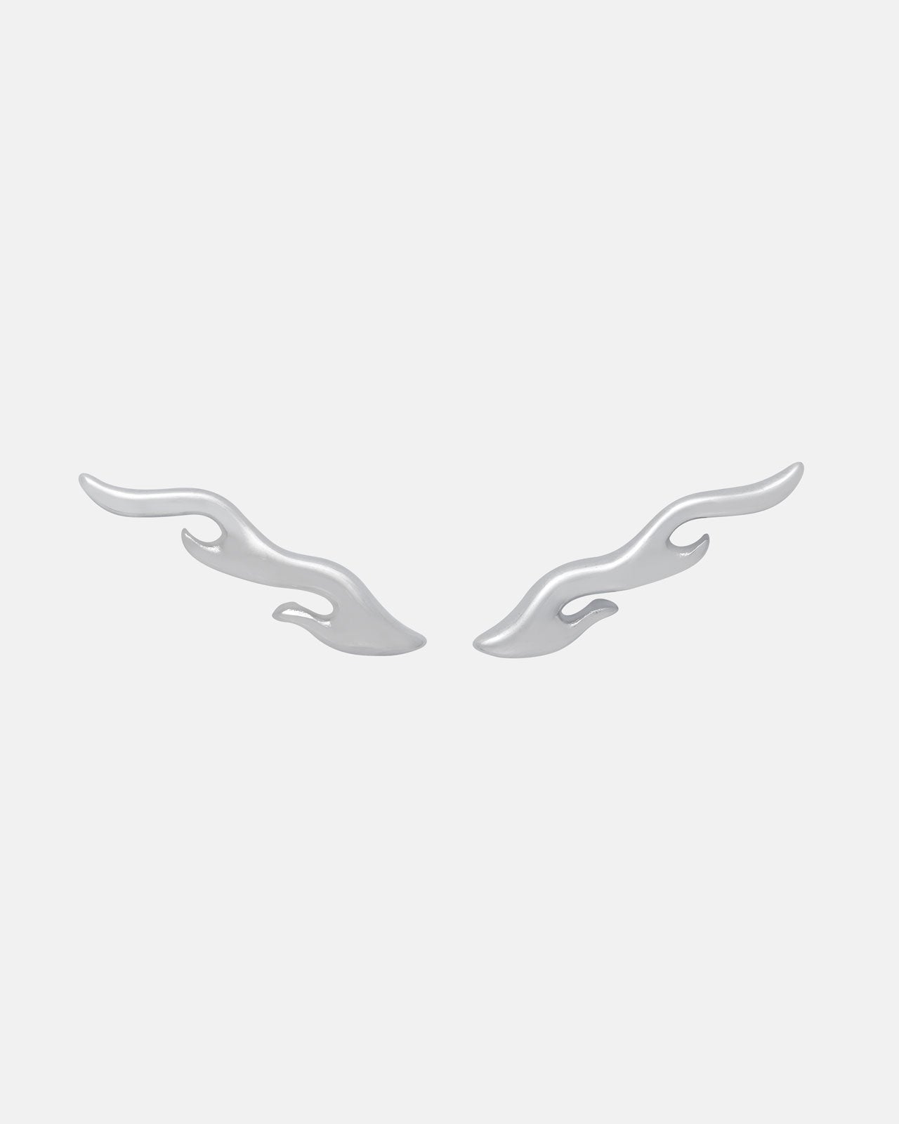 The Statement Collective "Pyro" Flame Earrings—two silver, wavy double-flame studs—are displayed symmetrically on a plain light gray background, highlighting their mirrored abstract design and bold style.