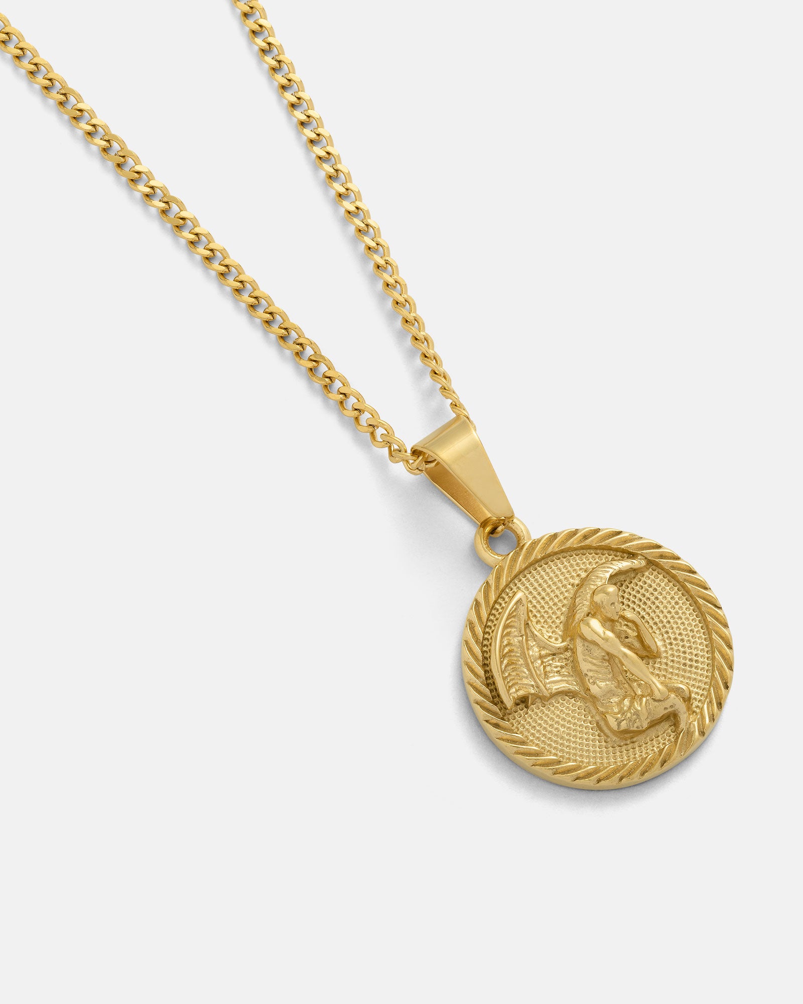 The Fallen Angel Medallion Pendant (Gold) is an 18k gold necklace with a textured round medallion featuring an embossed angel, suspended on a gold curb chain. This waterproof, non-tarnish piece shines on a plain light background.