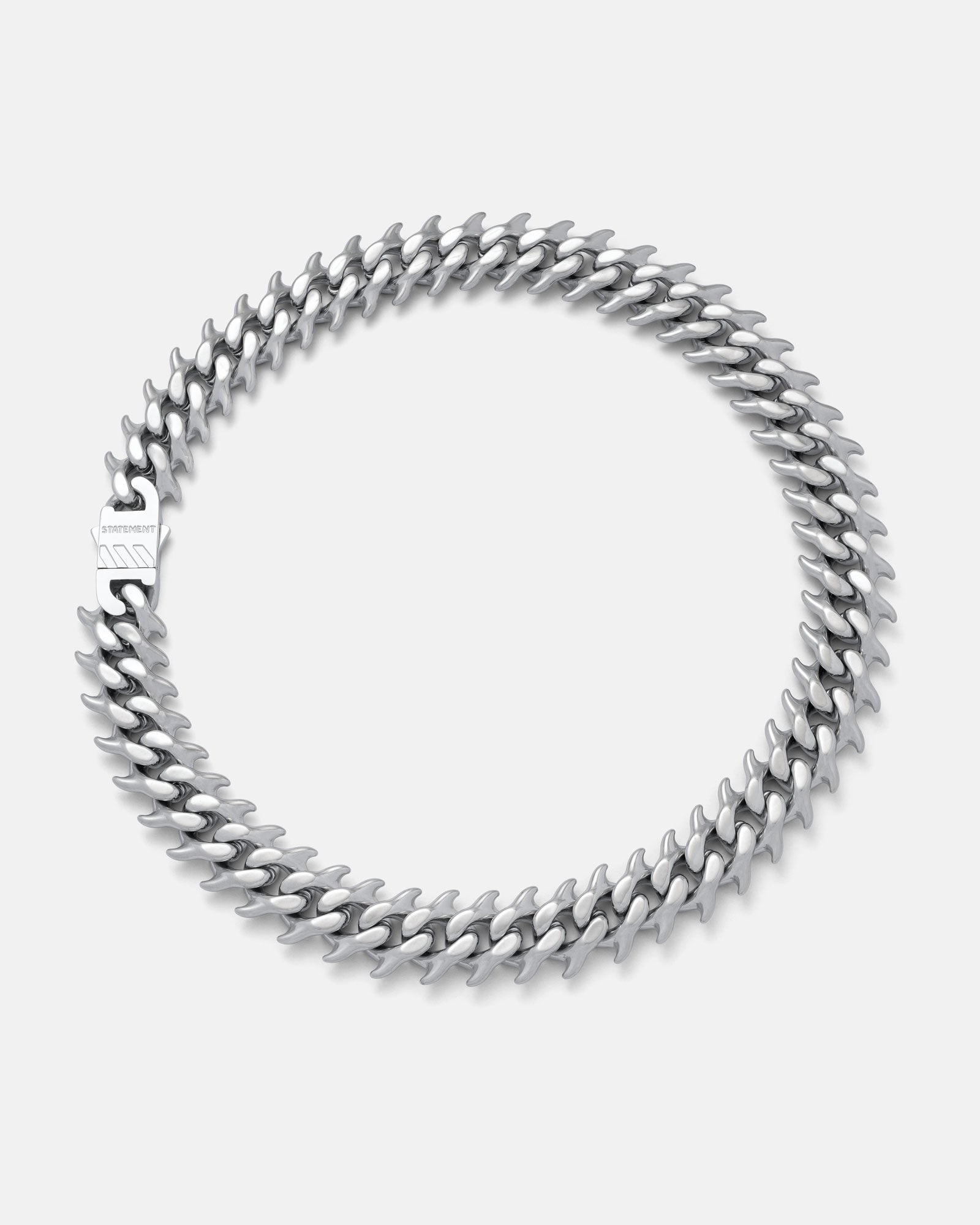 Curved spiked cuban chain on grey background