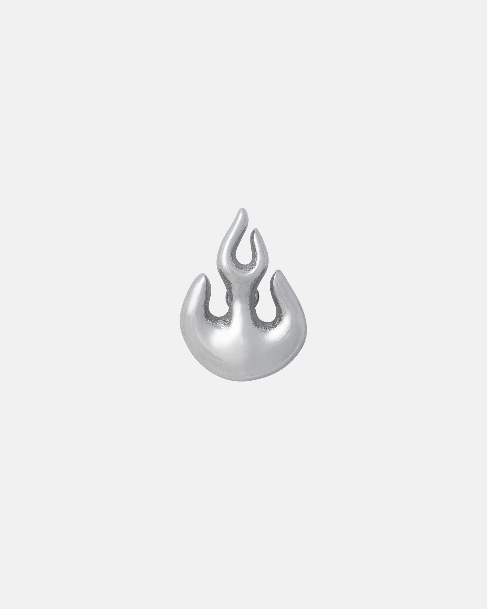 The Flame Stud Earring is a small, silver, abstract flame-shaped stud with smooth, rounded edges. Crafted from hypoallergenic stainless steel, it's displayed on a plain light gray background.