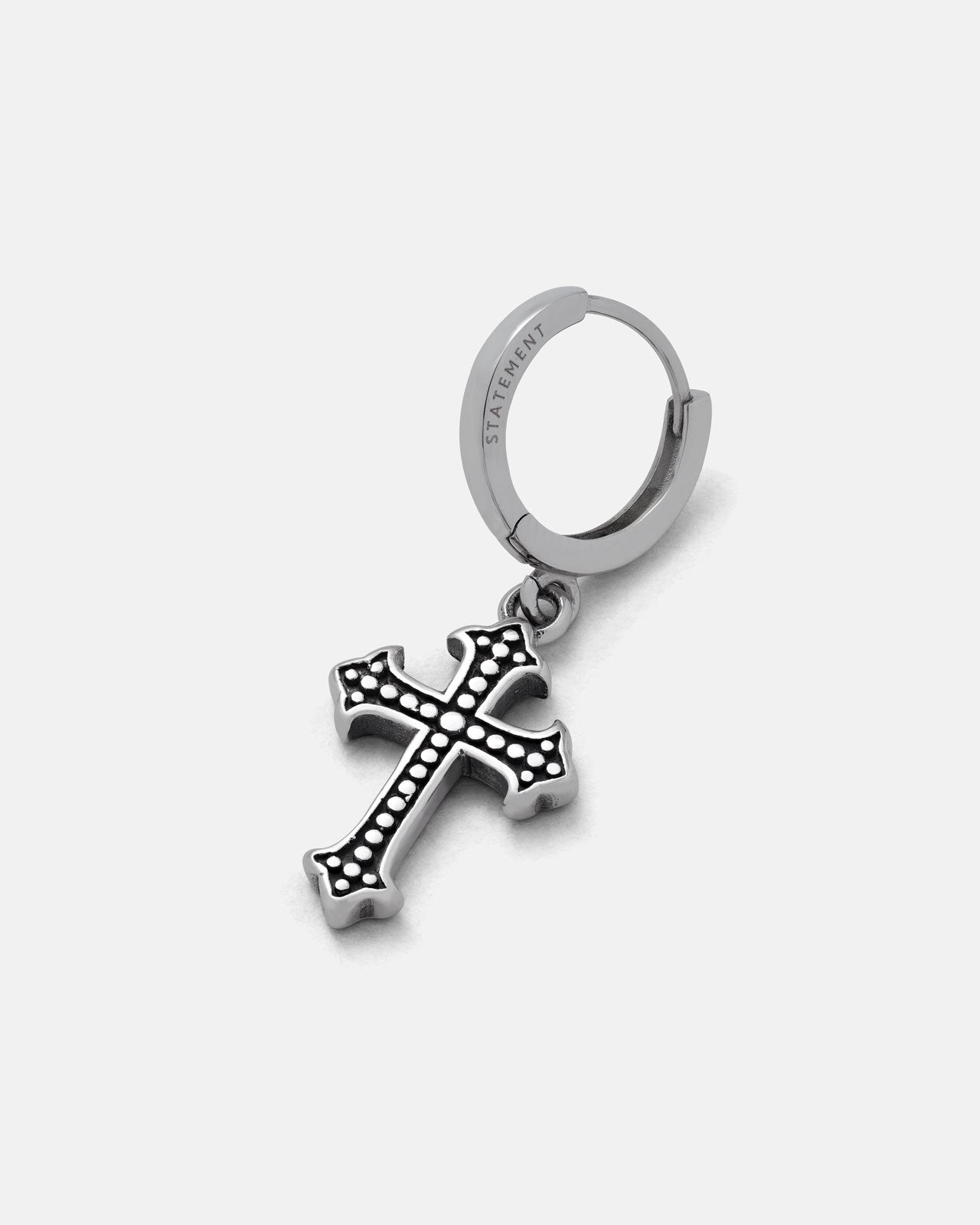 The French Cross Earring by Statement Collective features a silver hoop with a dangling cross pendant adorned with raised dots—an ideal choice for stylish men's cross earrings, shown on a light gray background.
