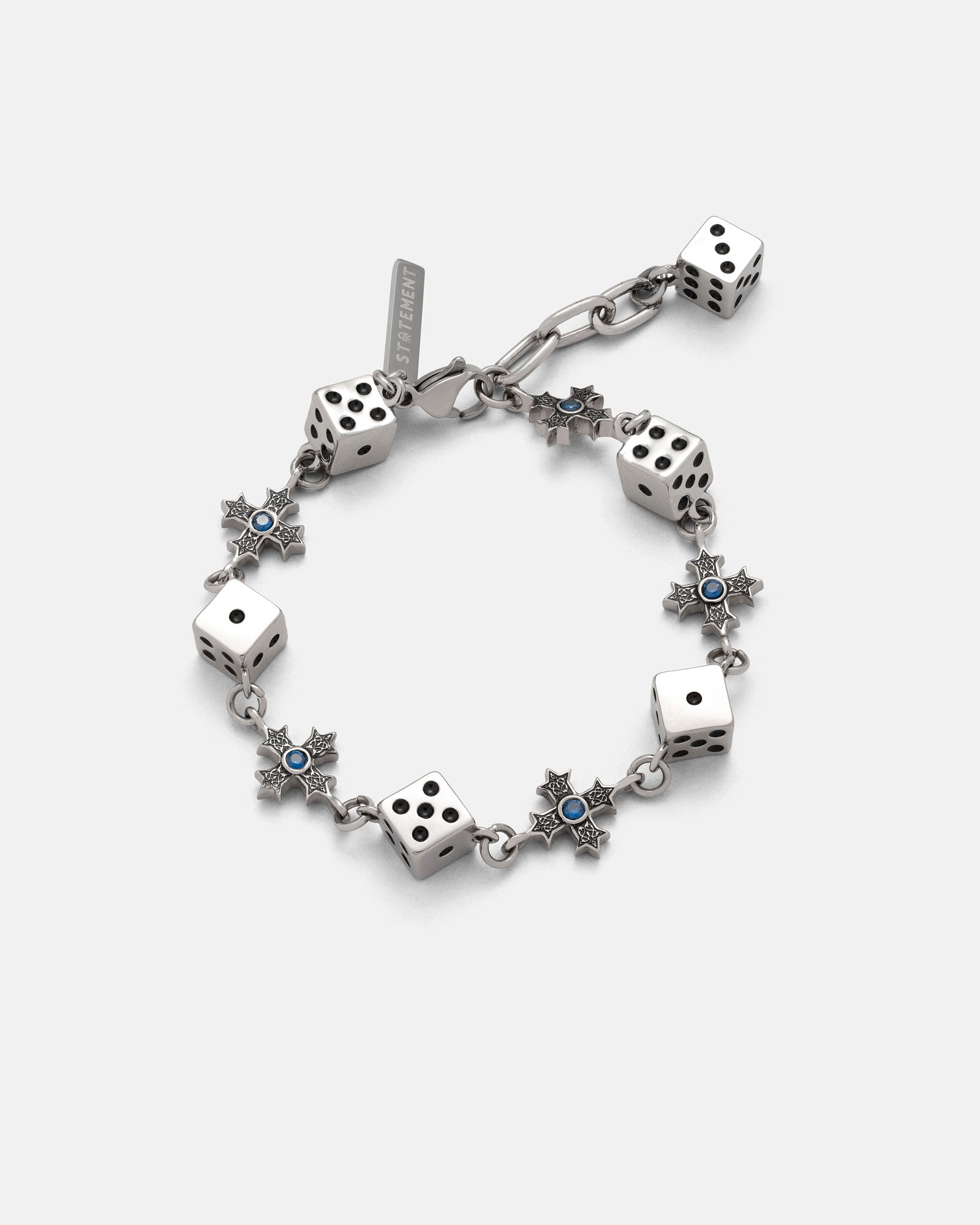 The Gambler’s Faith Bracelet by Statement Collective showcases silver six-sided dice and star-shaped links with blue centers, arranged in an alternating pattern, displayed on a plain light background.