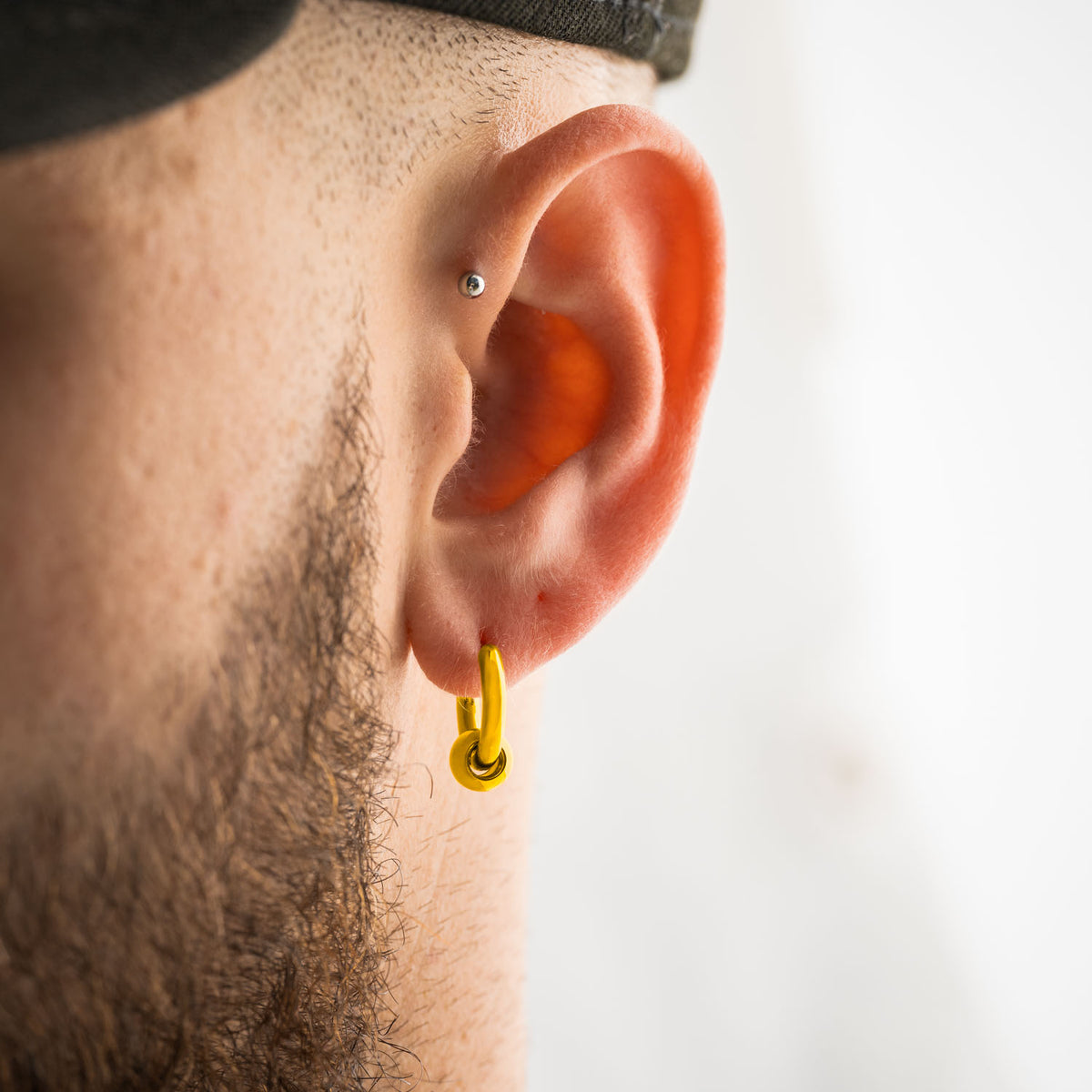 gold hoop earring mens ear with ball bead