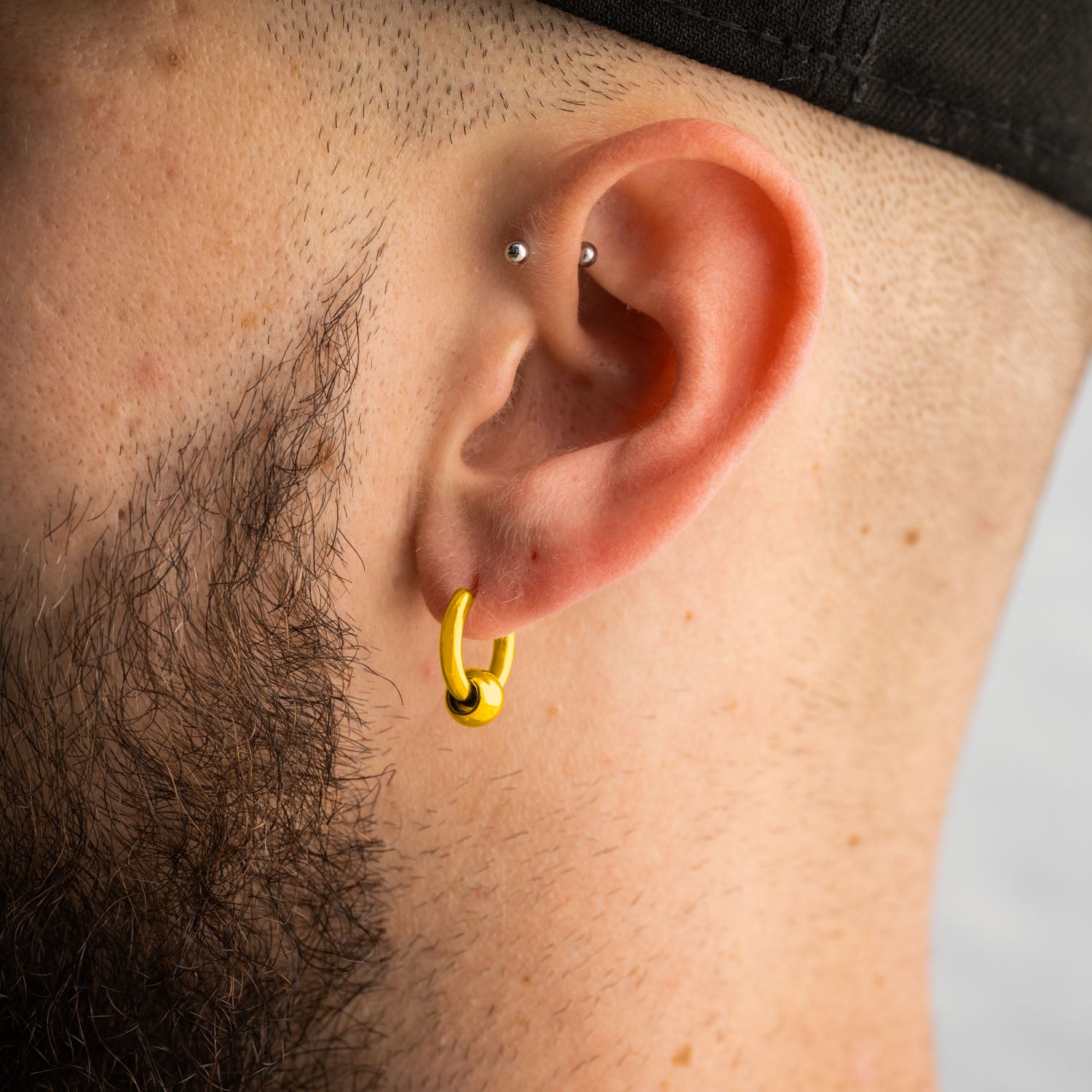 mens ear with gold hoop ball earring