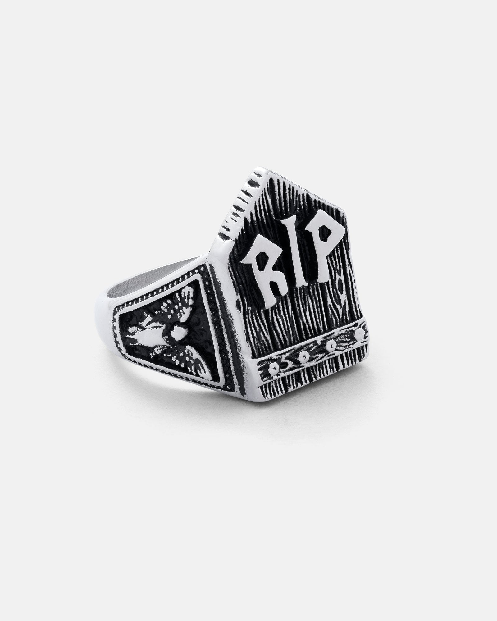 The Gravestone Ring is a silver, tombstone-shaped piece with "RIP" engraved on the front and an owl design on the side. It features a dark, textured finish for bold contrast.