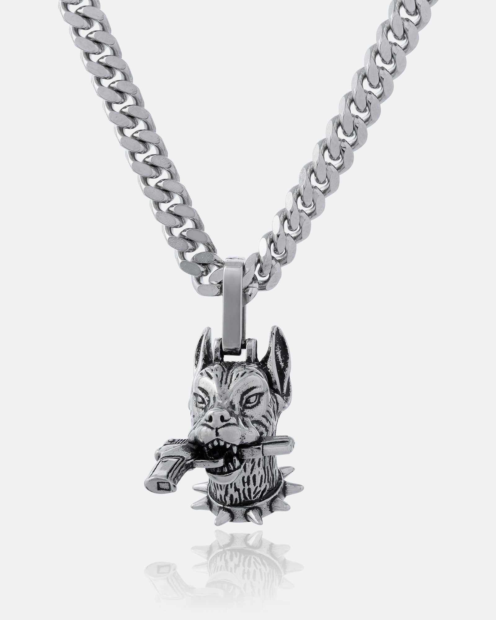 The Guard Dog" Pendant is a silver chain necklace with a Doberman head featuring pointed ears, a spiked collar, and a bone in its mouth—an ideal bold hip hop accessory for your street necklace collection.