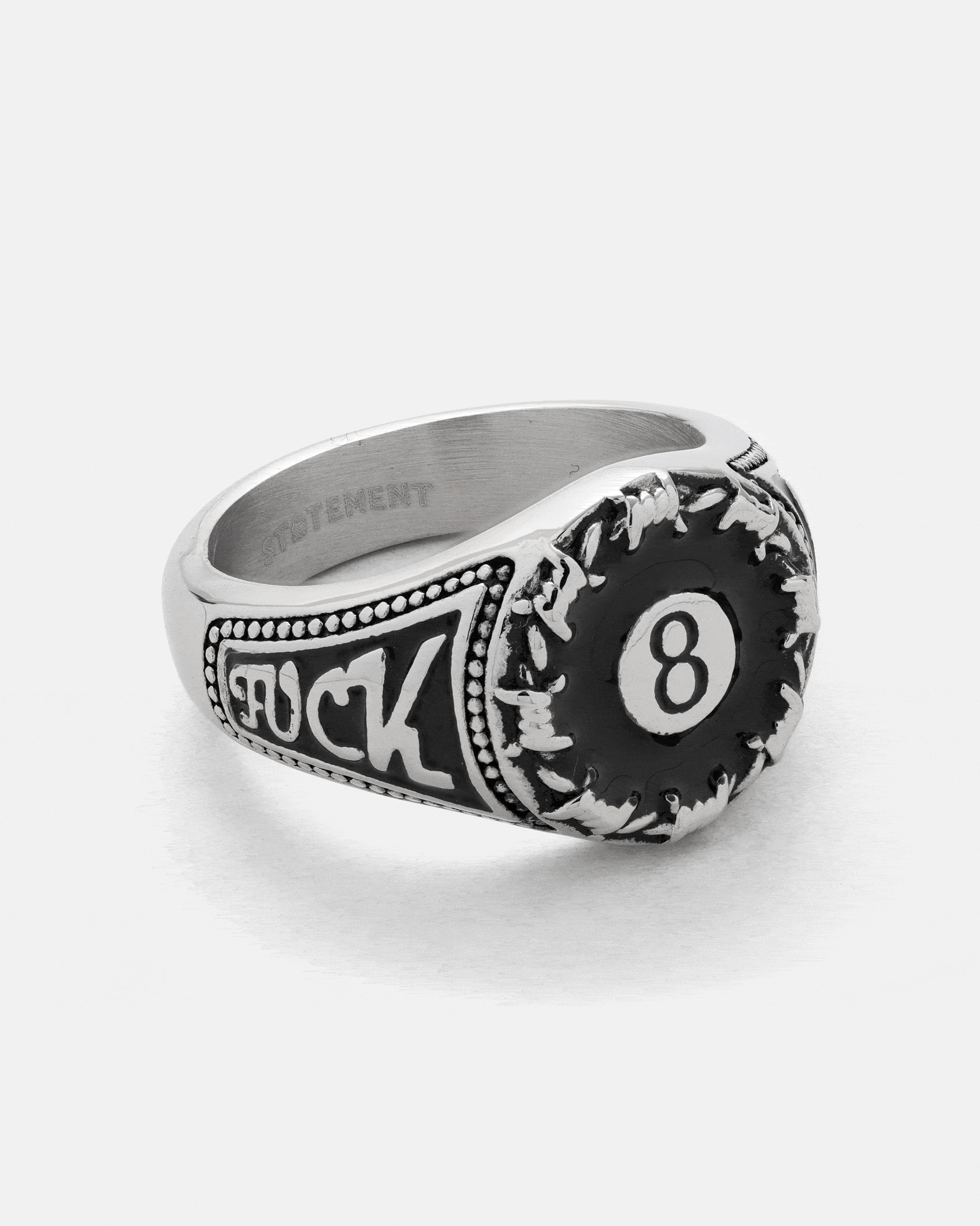 Lucky Shot Ring in stainless steel, featuring an 8-ball face with a black emblem and the word FUCK engraved on the side.