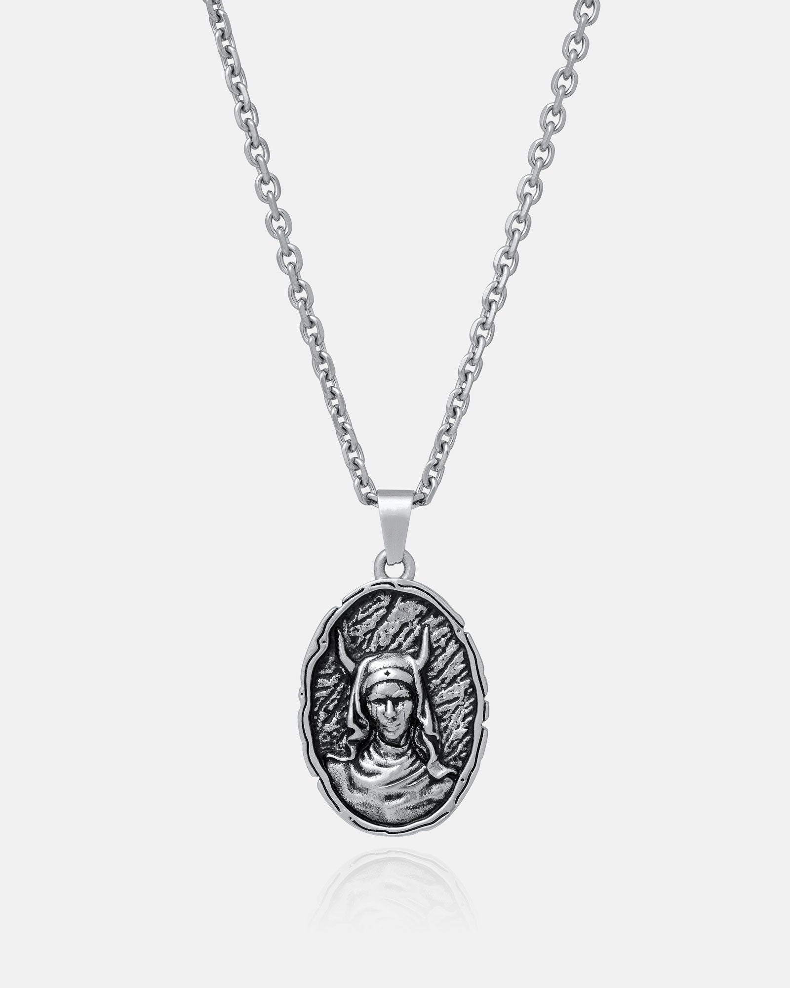 The Unholy" Pendant is a silver gothic necklace with an oval pendant engraved in relief with a helmeted figure on a textured background, crafted from durable 316L stainless steel for lasting shine and strength.