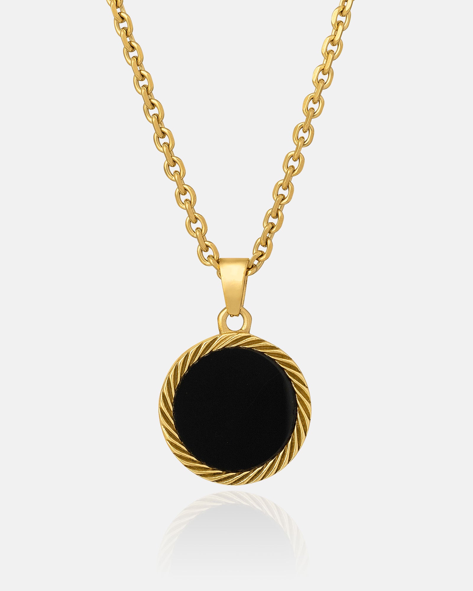 The Onyx Medallion Pendant (Gold) is a gold chain necklace with a round black agate onyx pendant and a twisted gold border, shown against a plain white background.