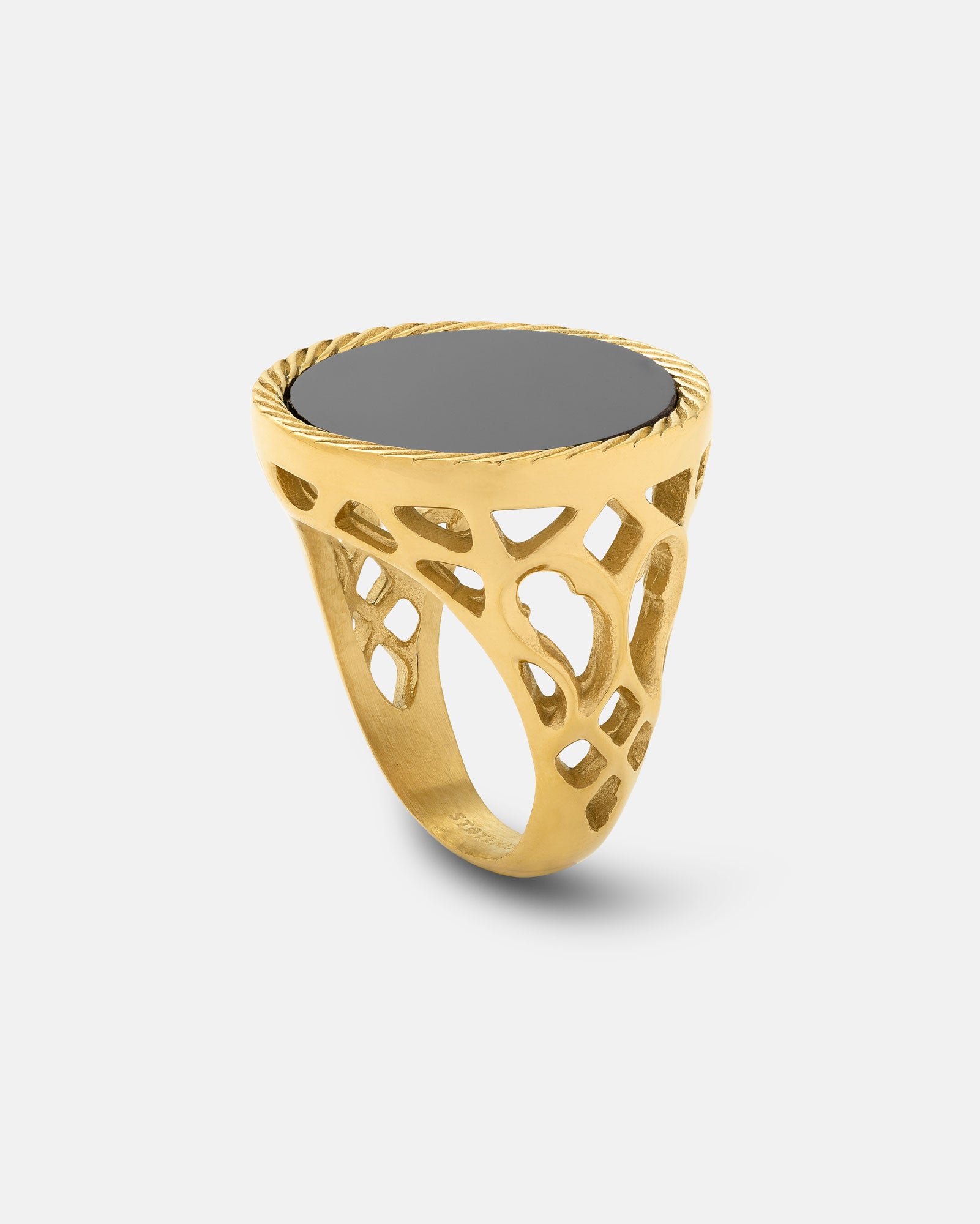 The Onyx Sovereign Ring (Gold) features an ornate openwork band and a flat, oval black onyx stone, displayed against a plain light background—an ideal men’s statement jewelry piece.