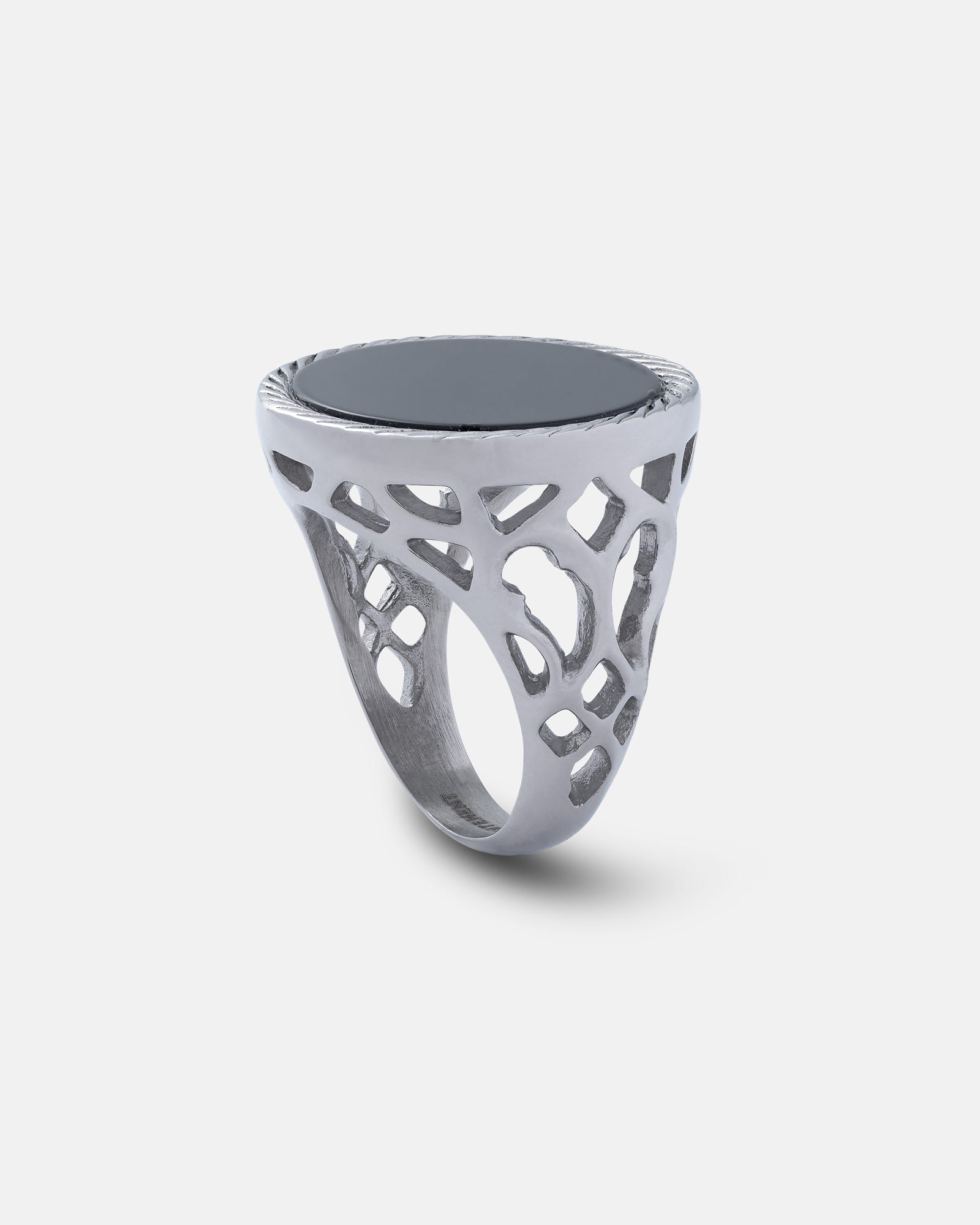 Silver onyx signet ring with intricate lattice pattern on white background by statement collective