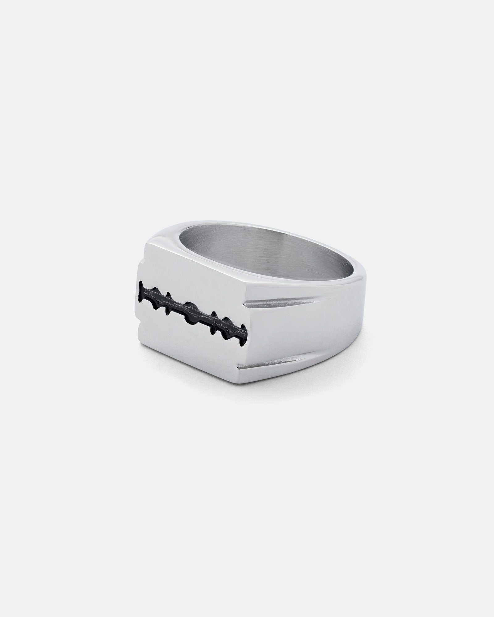 The Razor Blade Signet Ring features a stainless steel, flat rectangular top with black detailing and a polished band, giving this punk-inspired piece a modern edge against a plain white background.