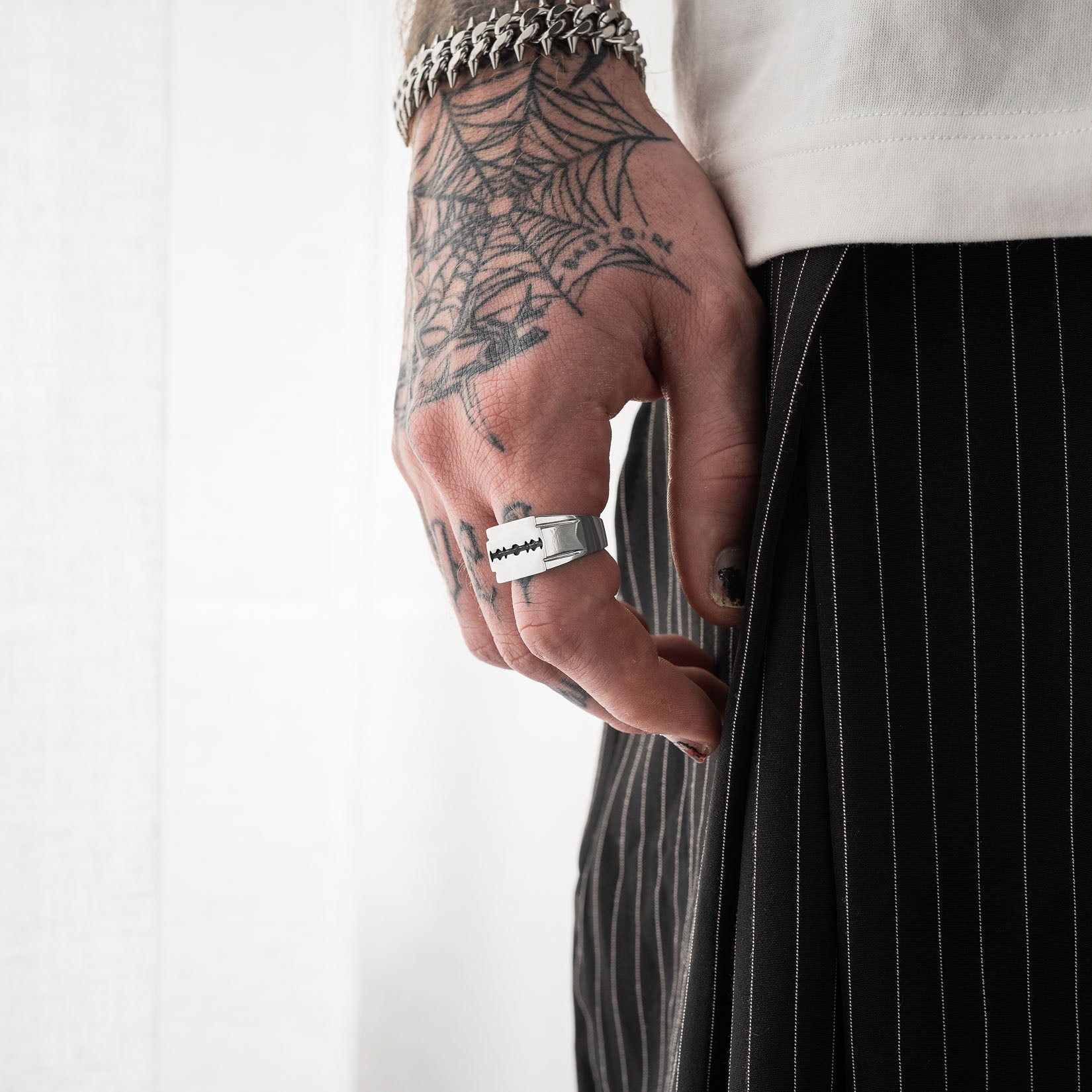 Razorblade signet ring on mens hand by statement collective