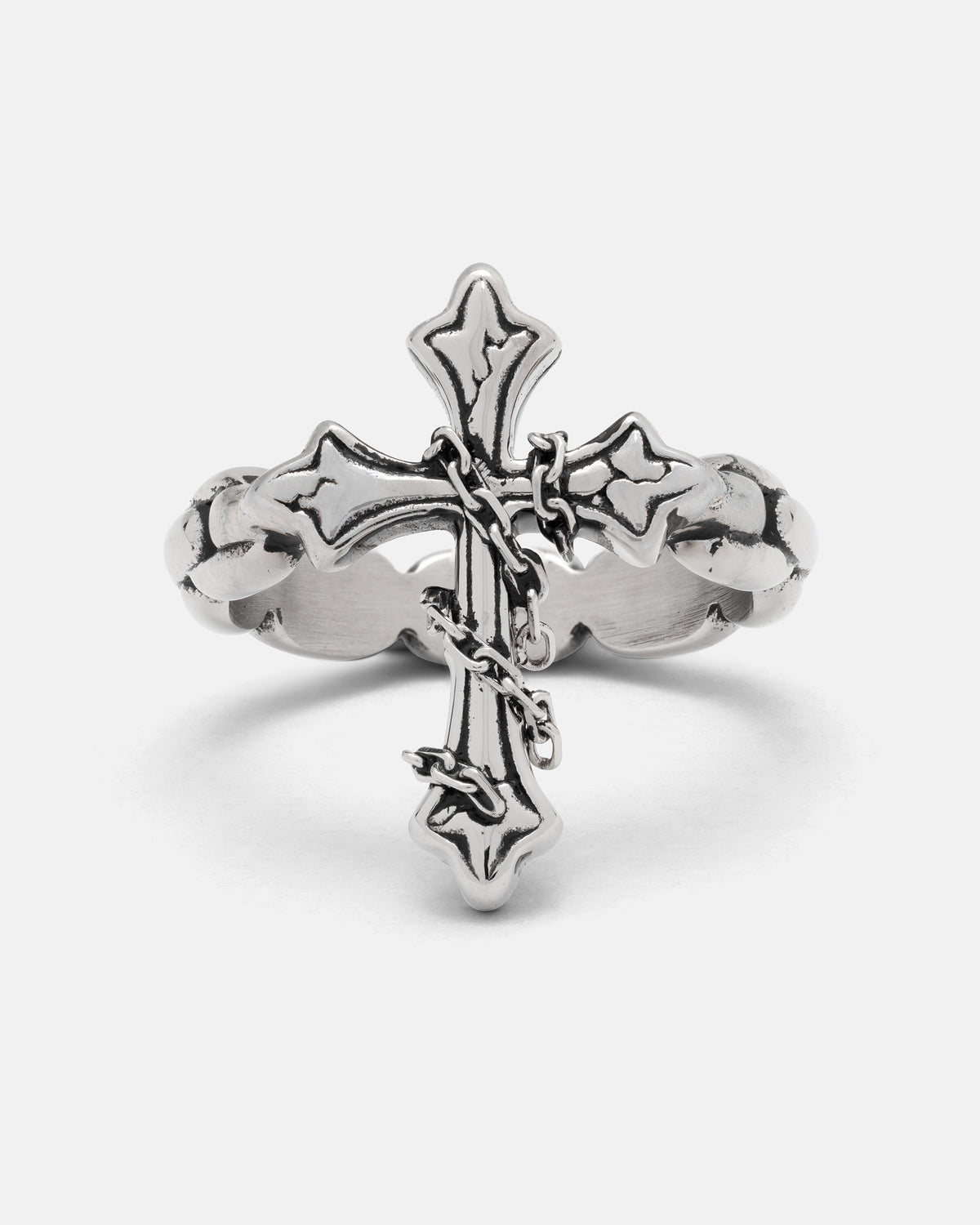 The Ruins Chained Cross Ring, a stainless steel ring featuring a decorative cross wrapped in a small metal chain.