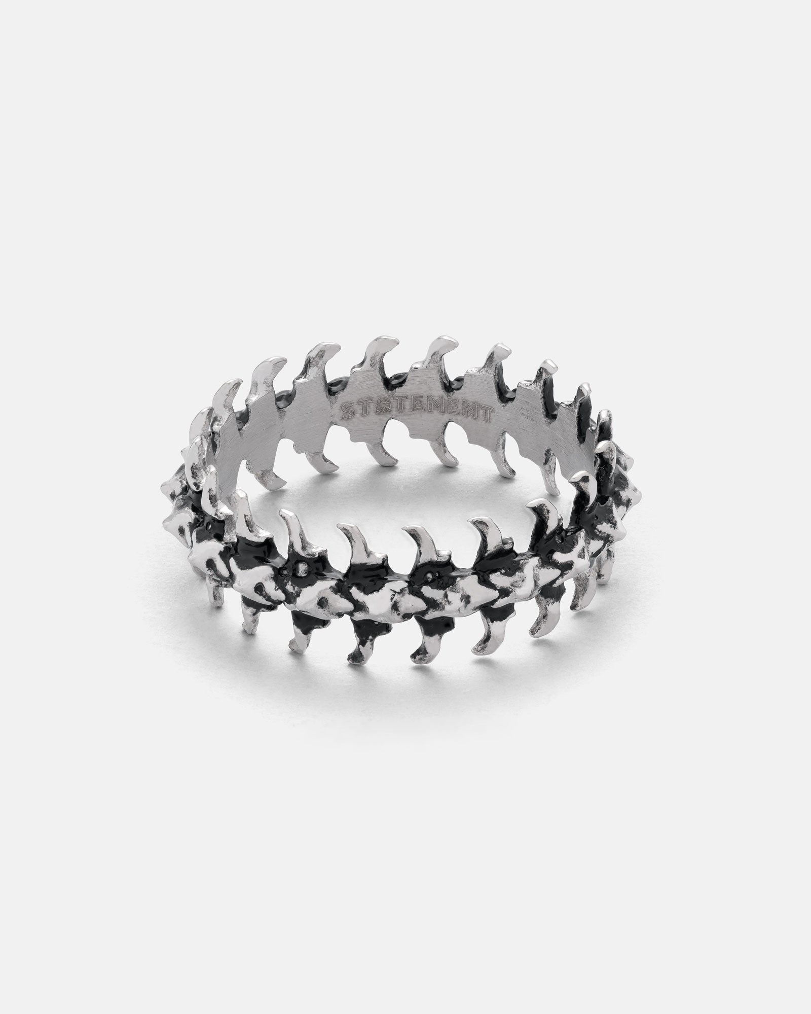 fishbone design ring laying flat on white background