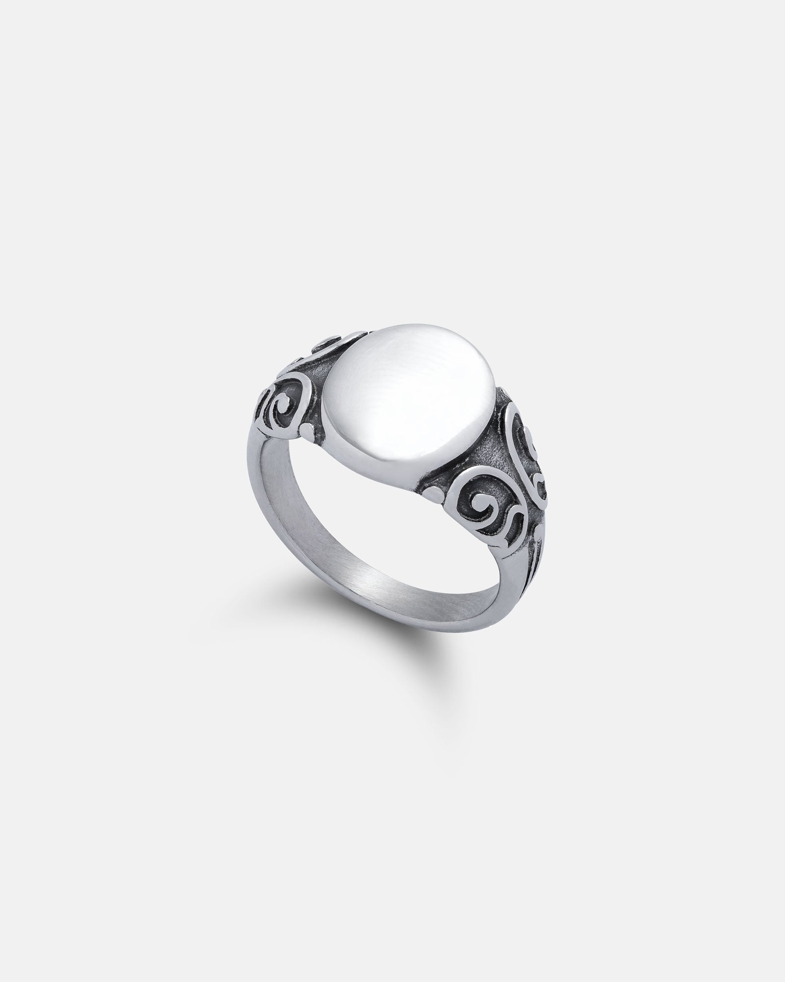 oval scroll signet ring with intricate patterns on white background
