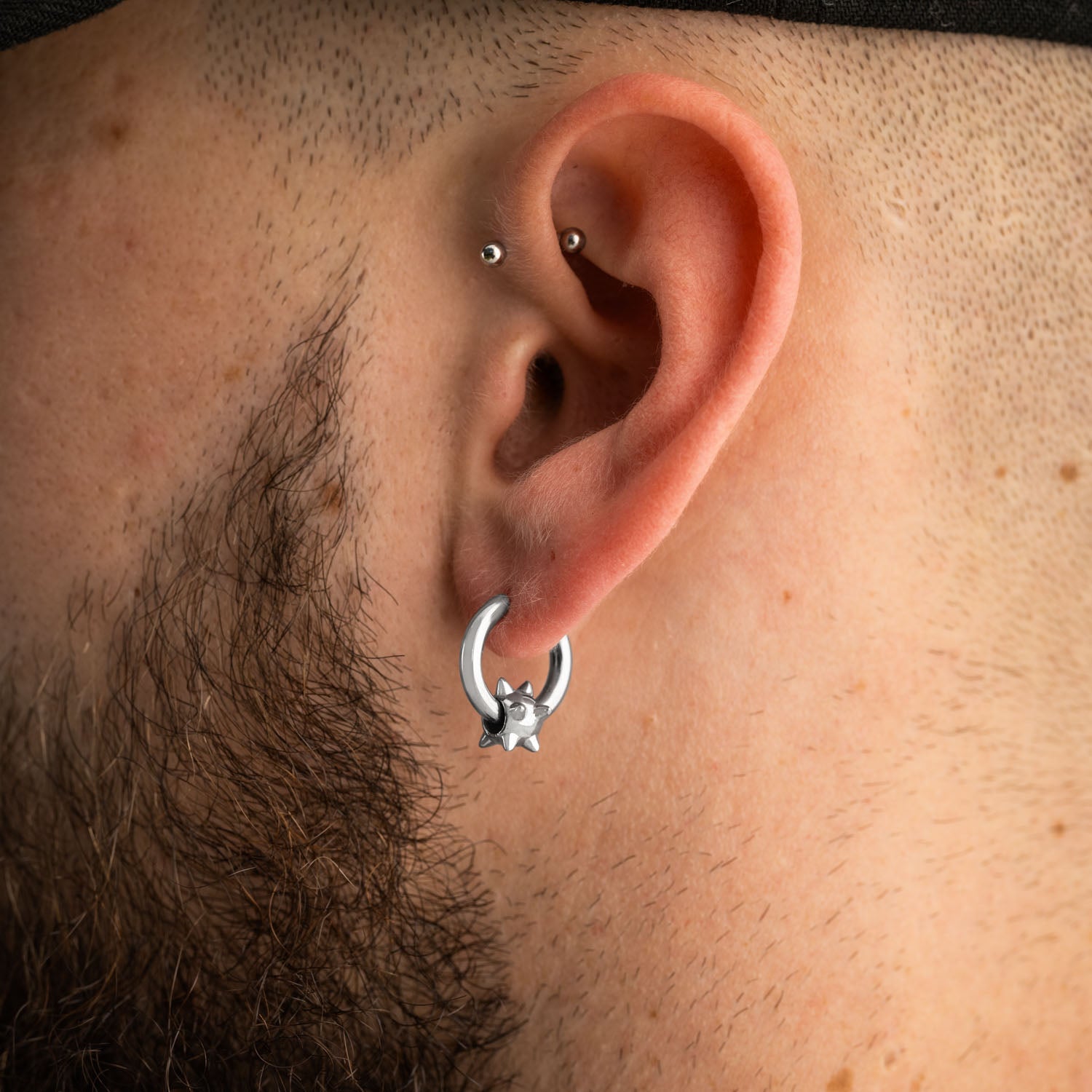 mens ear with silver spiked ball hoop earring