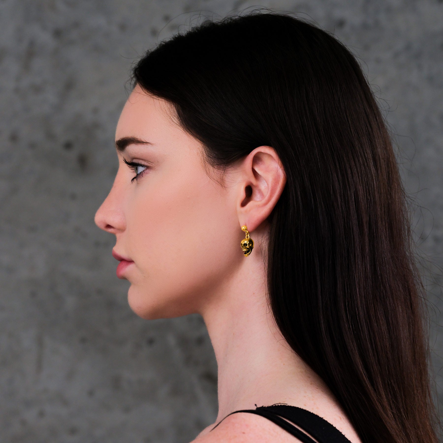 Pirate skull gold stud earring on body