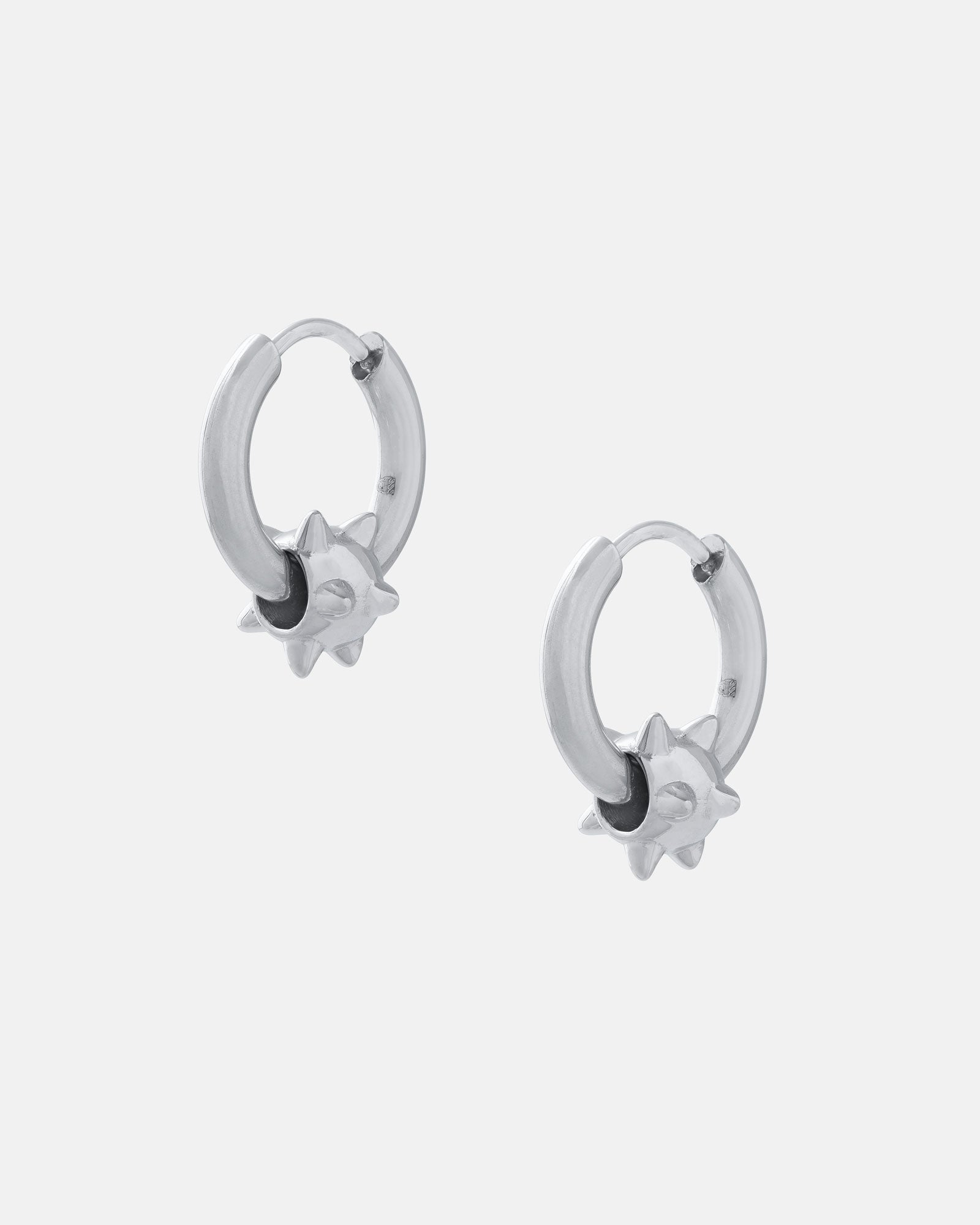 The "Morning Star" Earrings feature silver hypoallergenic stainless steel hoops with small spiked charms, are waterproof, and perfect for everyday wear. Shown against a light gray background.