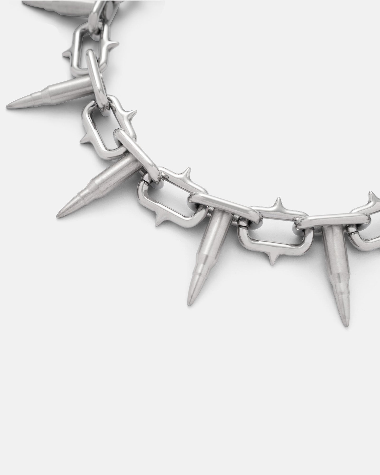 A close-up of the Statement Collective "Sweating Bullets" Necklace Chain: a 12mm heavy-duty stainless steel design with bullet-shaped pendants and spiked metal links, displayed on a plain white background.