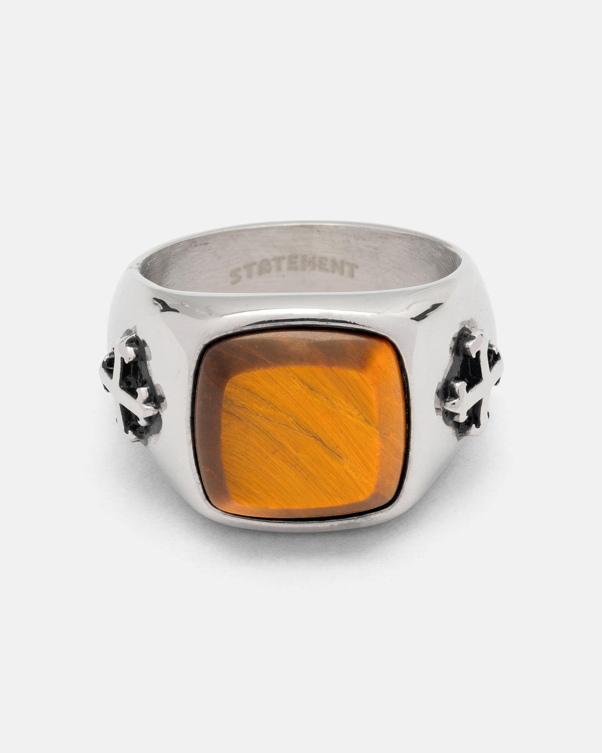 Statement Collective Tigers Eye Stone Ring, a stainless steel signet ring featuring a square tigers eye stone and cross accents on the sides.
