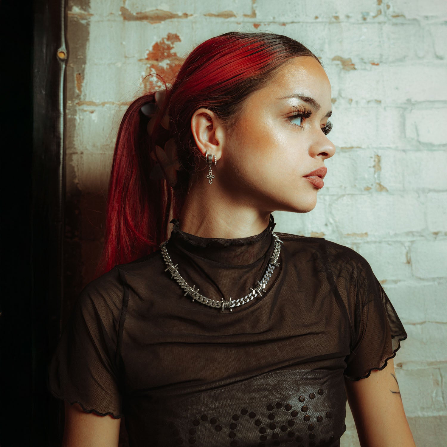 Sterling Silver 9mm Barbed wire chain on female model in mesh shirt with earrings and red hair 