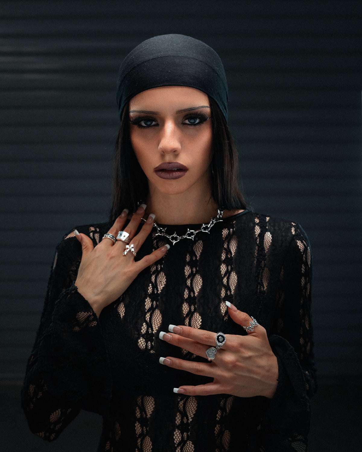 A person wearing the XL The Cathedral 15mm Spiked Chain, a gothic necklace featuring a spiked, cathedral-inspired design.