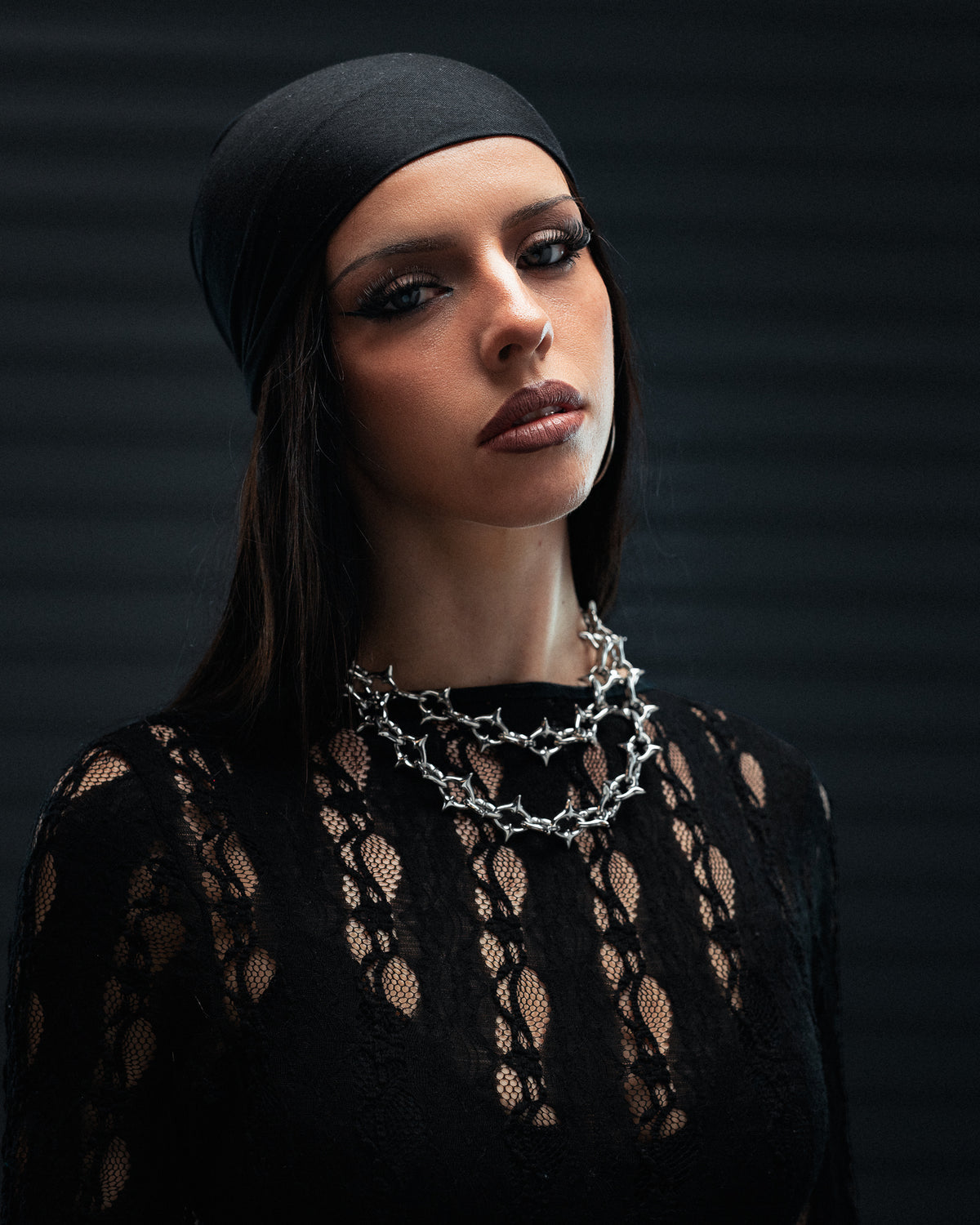 A person wearing an XL The Cathedral 15mm Spiked Chain gothic spiked necklace around their neck.