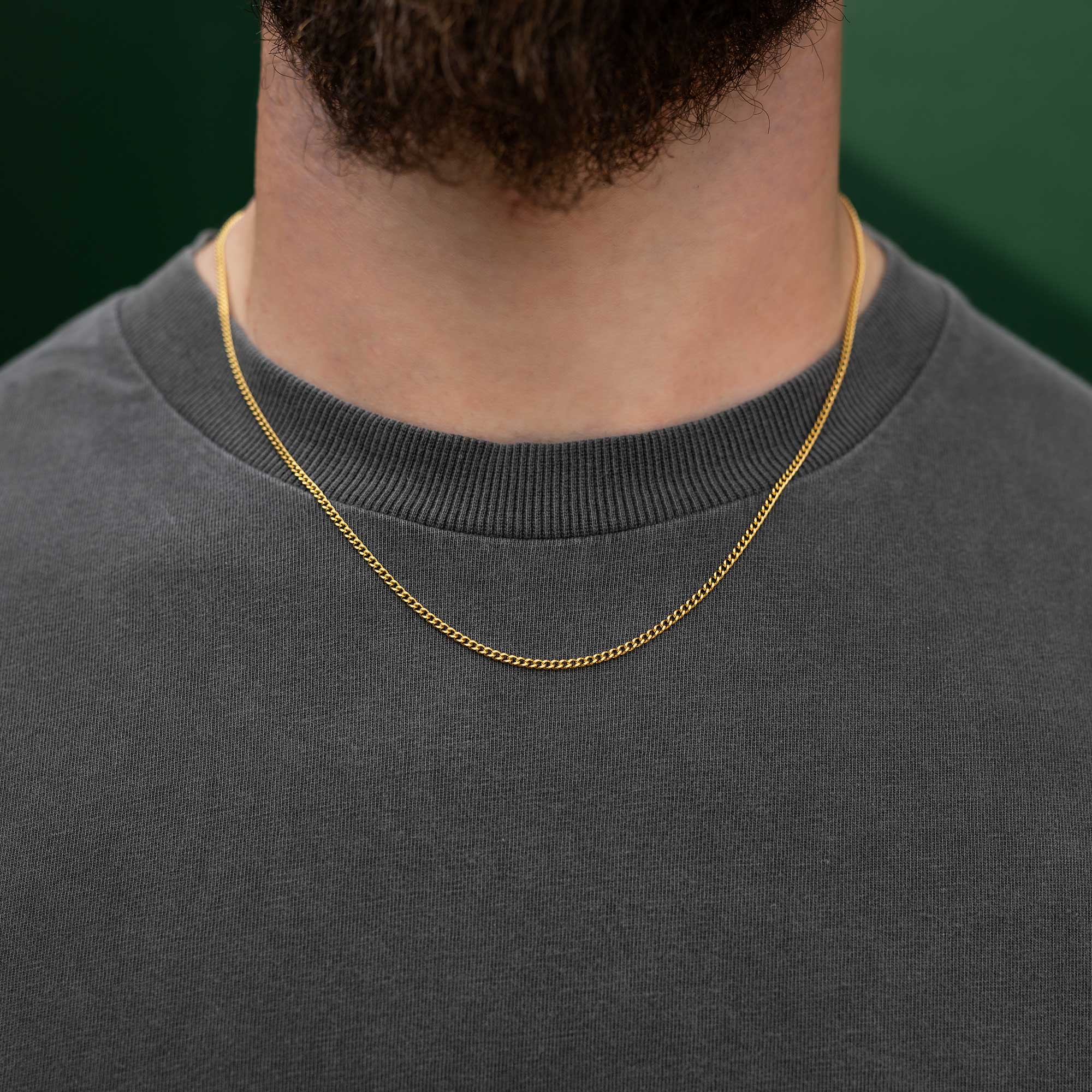 Dainty golden cuban chain on male model