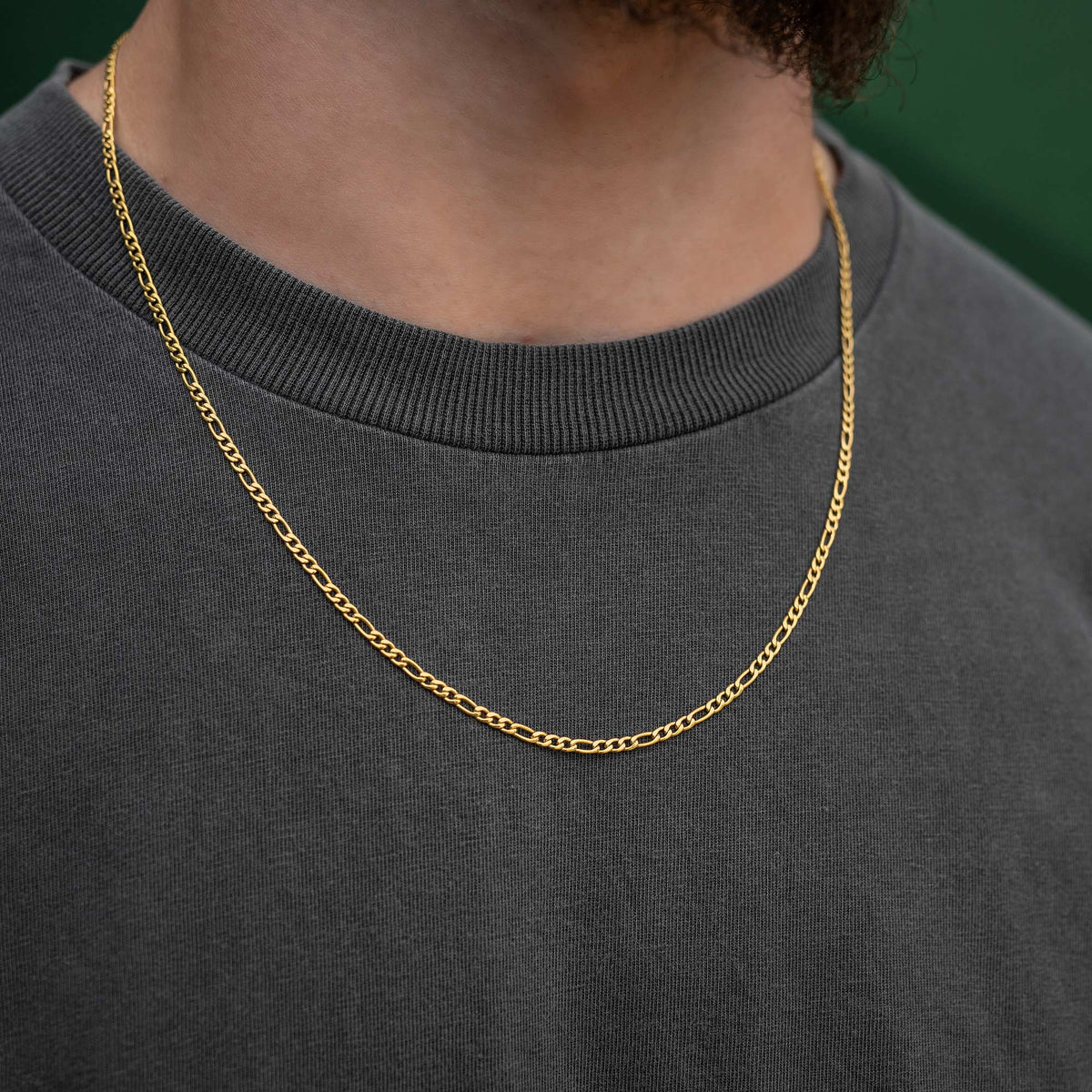 Mens figaro link necklace in gold on body 