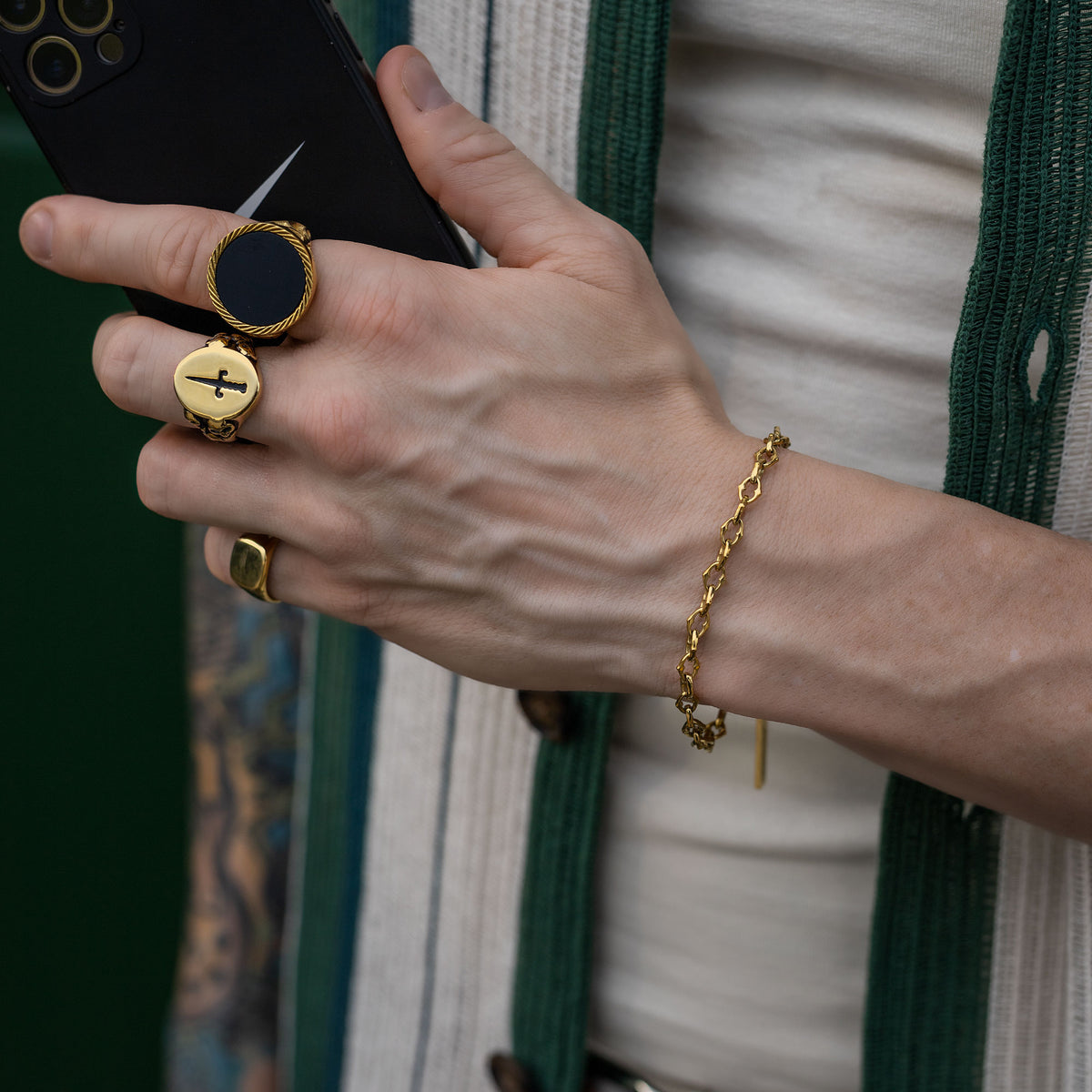 Spiked chain link bracelet with gold rings on model