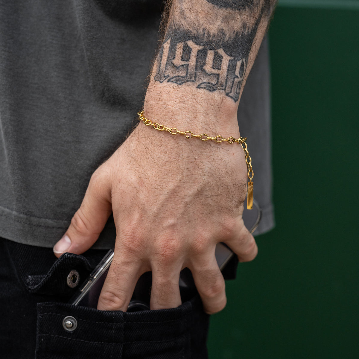 Gold Spiked chain bracelet on male model