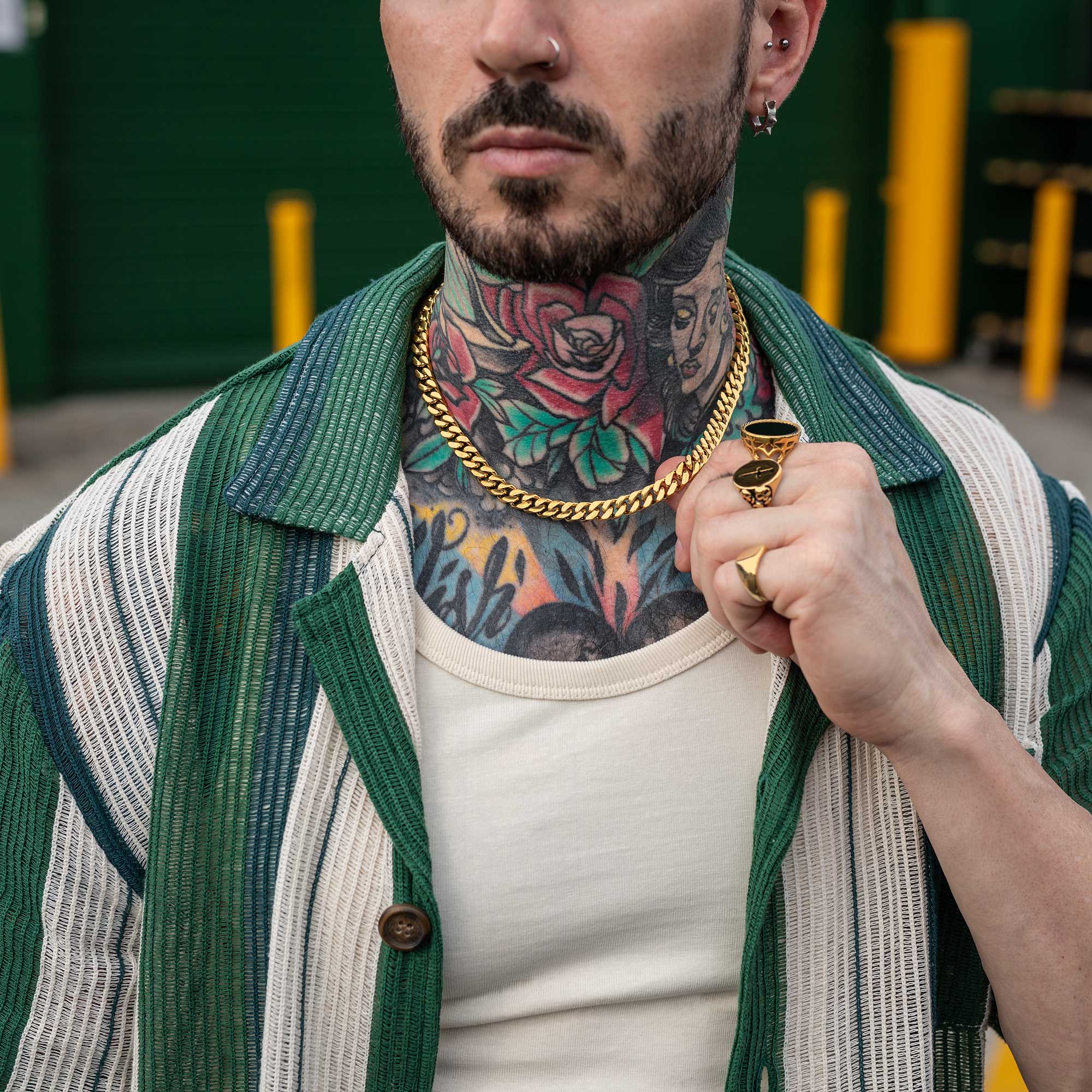 Gold Necklace with cuban links on tattooed male model