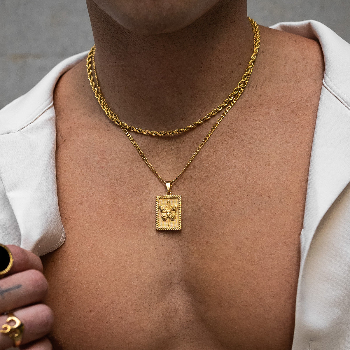 mens butterfly pendant chain in gold on body