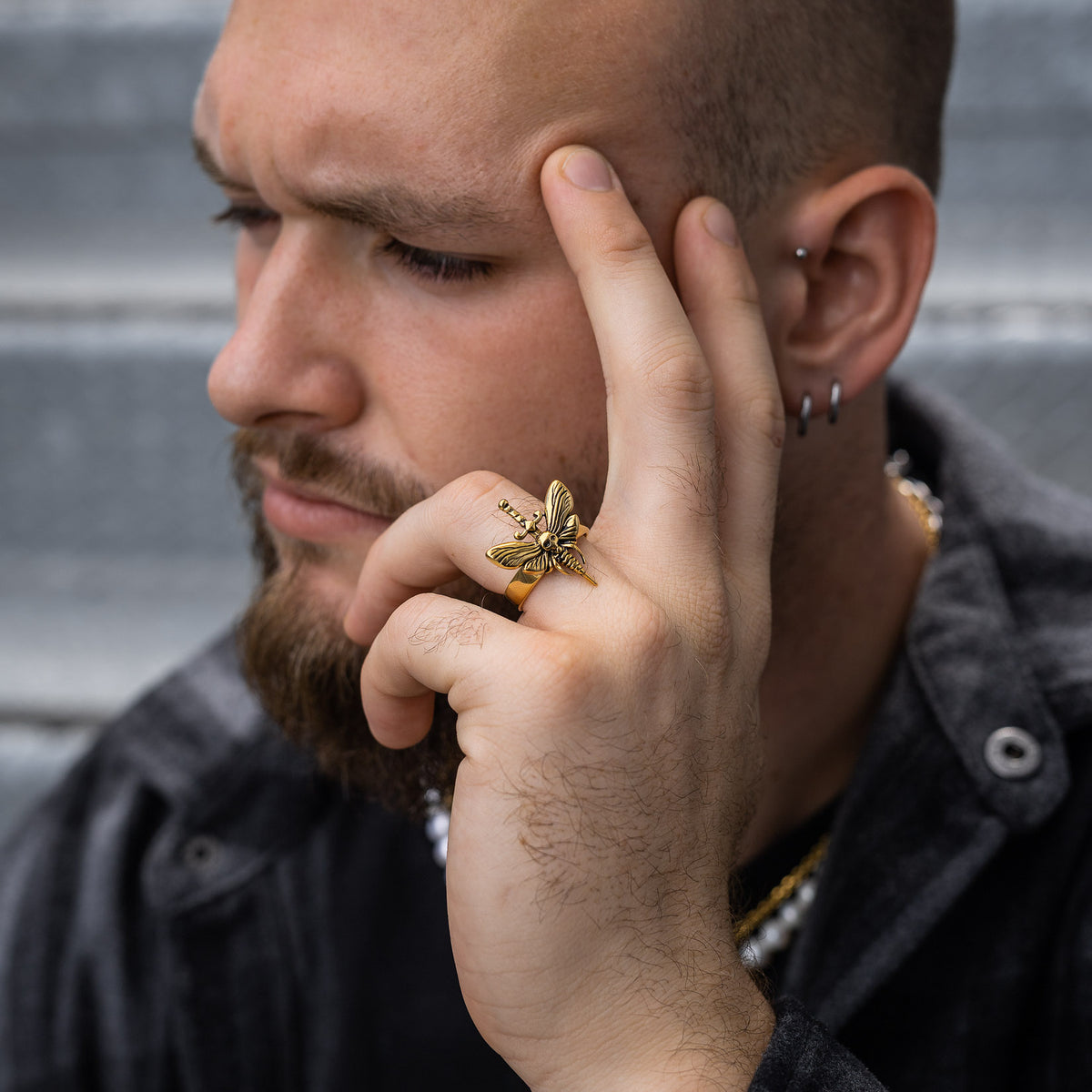 male model with death moth ring in gold