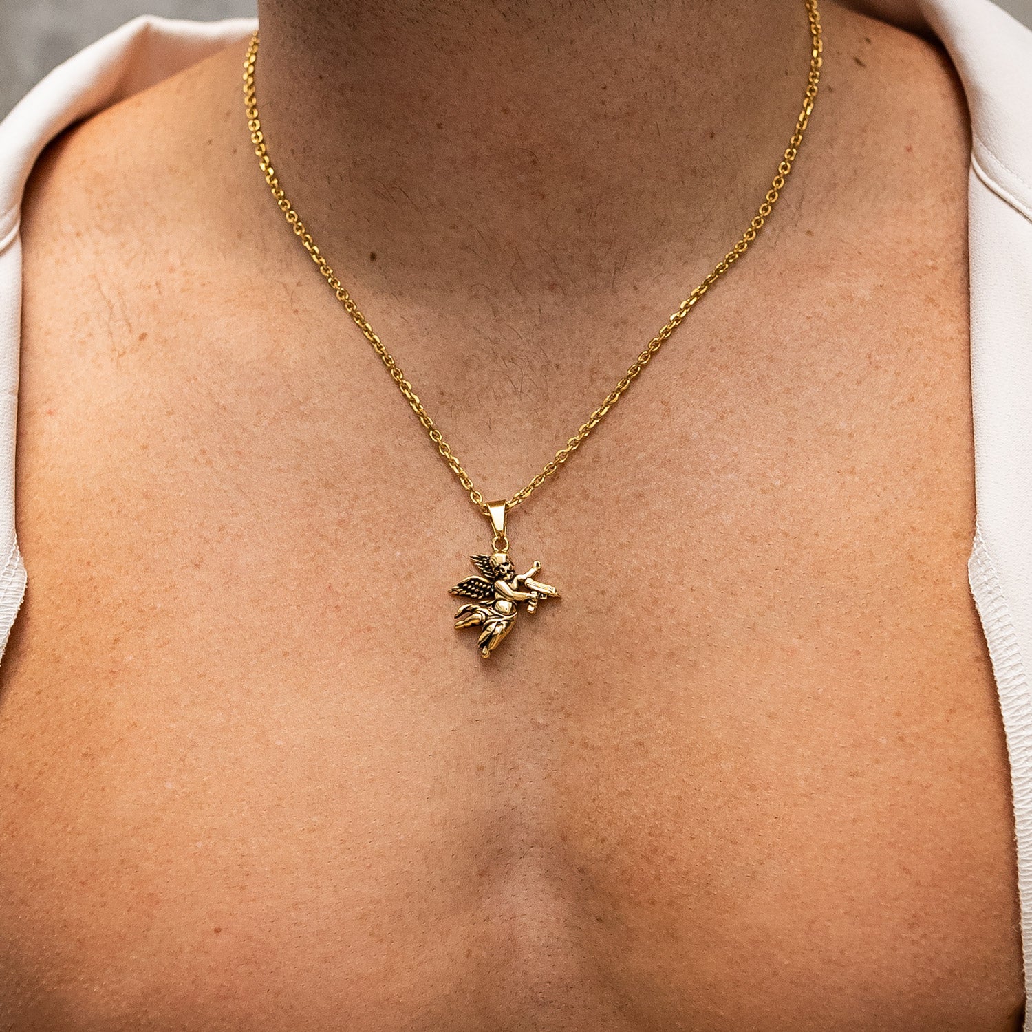 Gold cupid pendant chain on male model