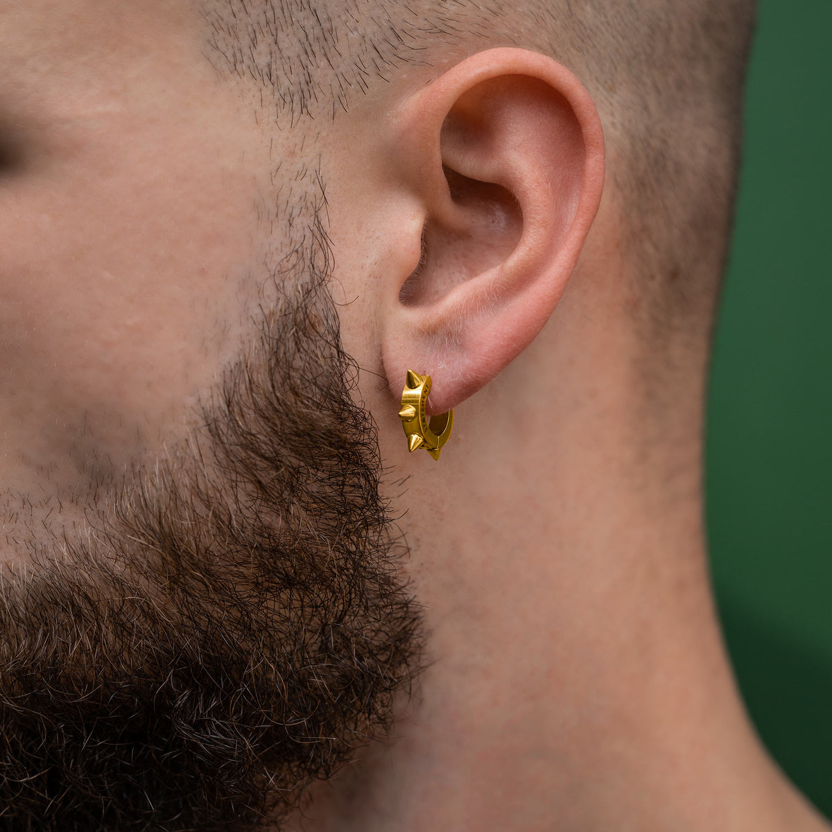 gold Spiked Hoop earring on male model 