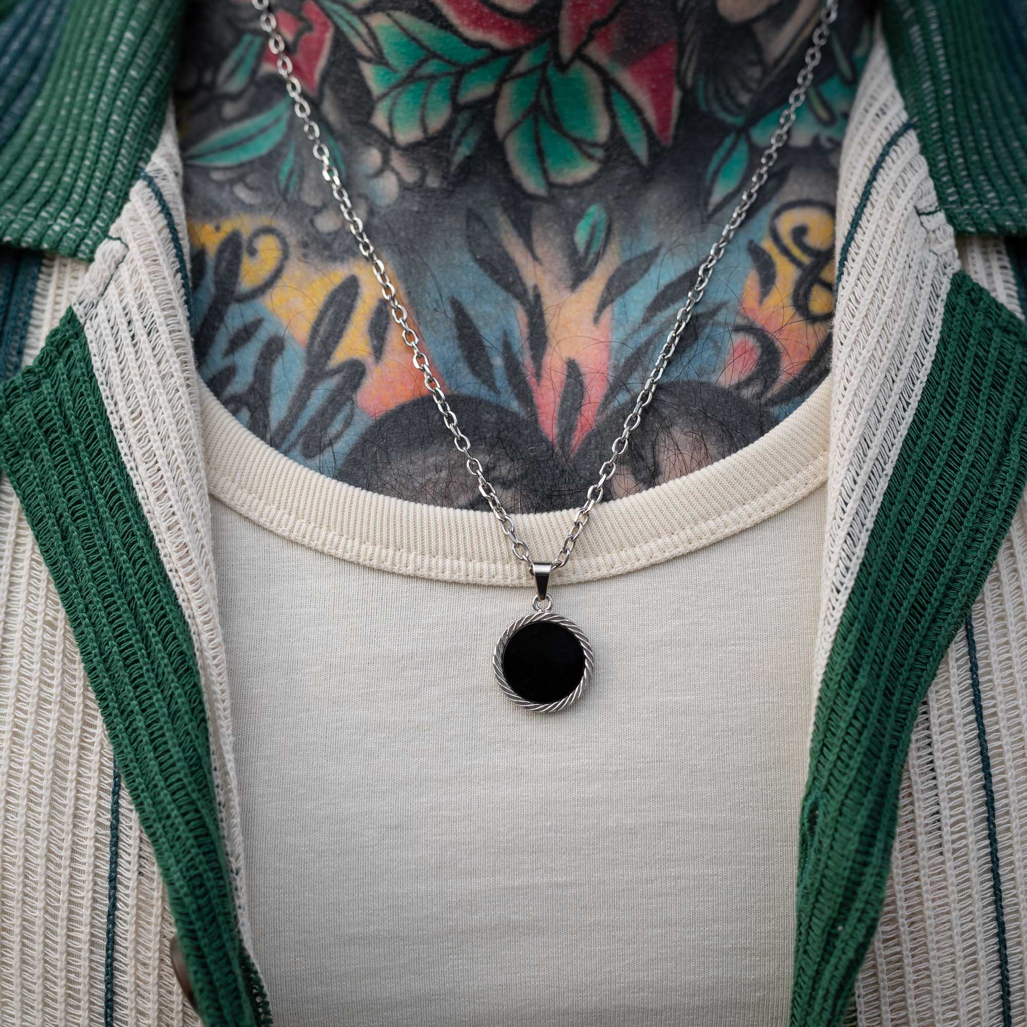 Male model with silver onyx stone medallion
