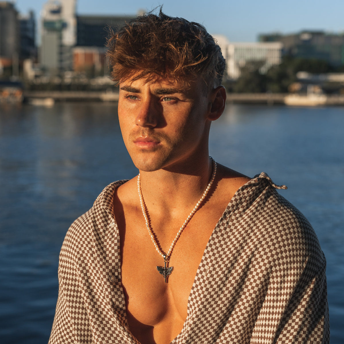 model wearing a pearl necklace for men