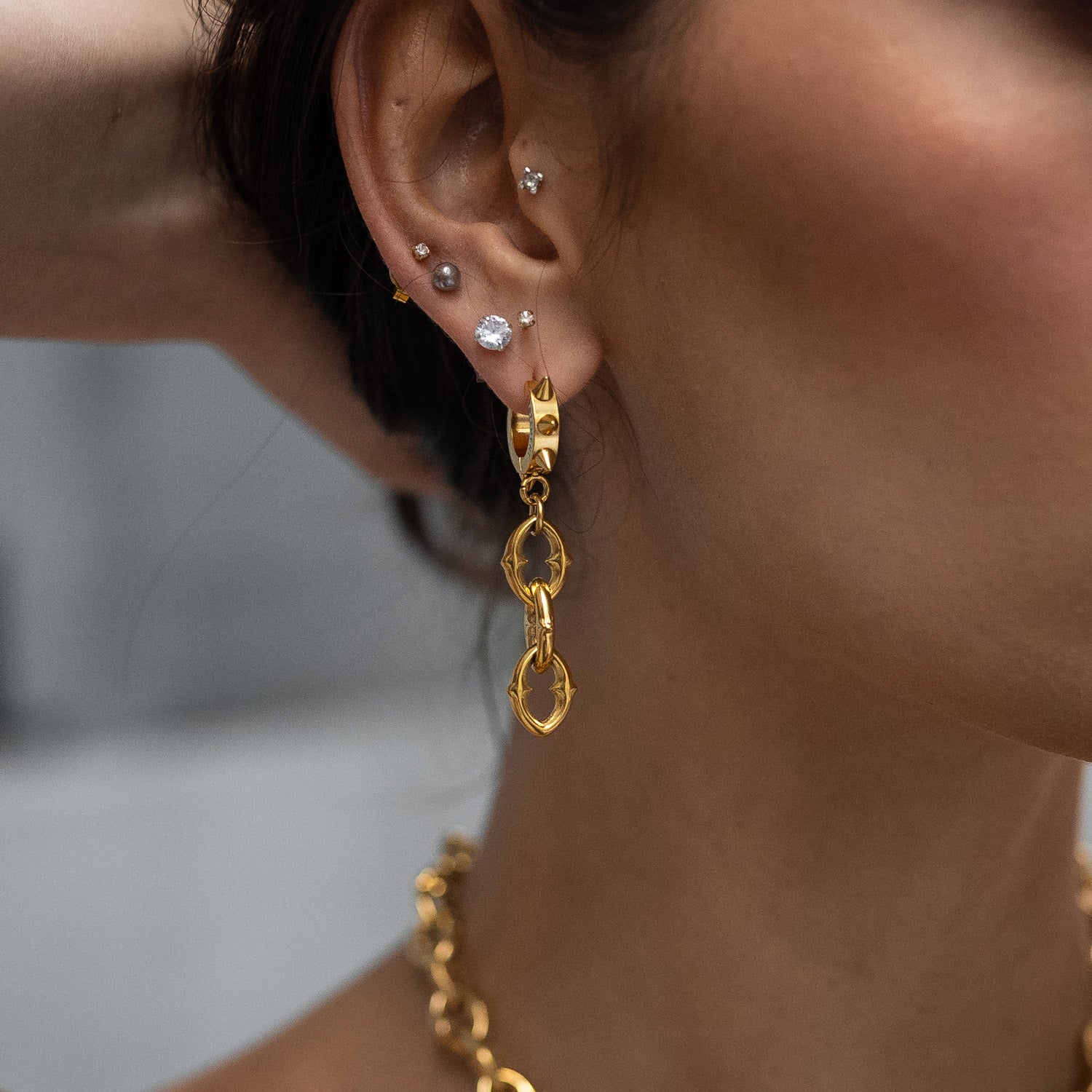 model wearing womens gold drop earrings
