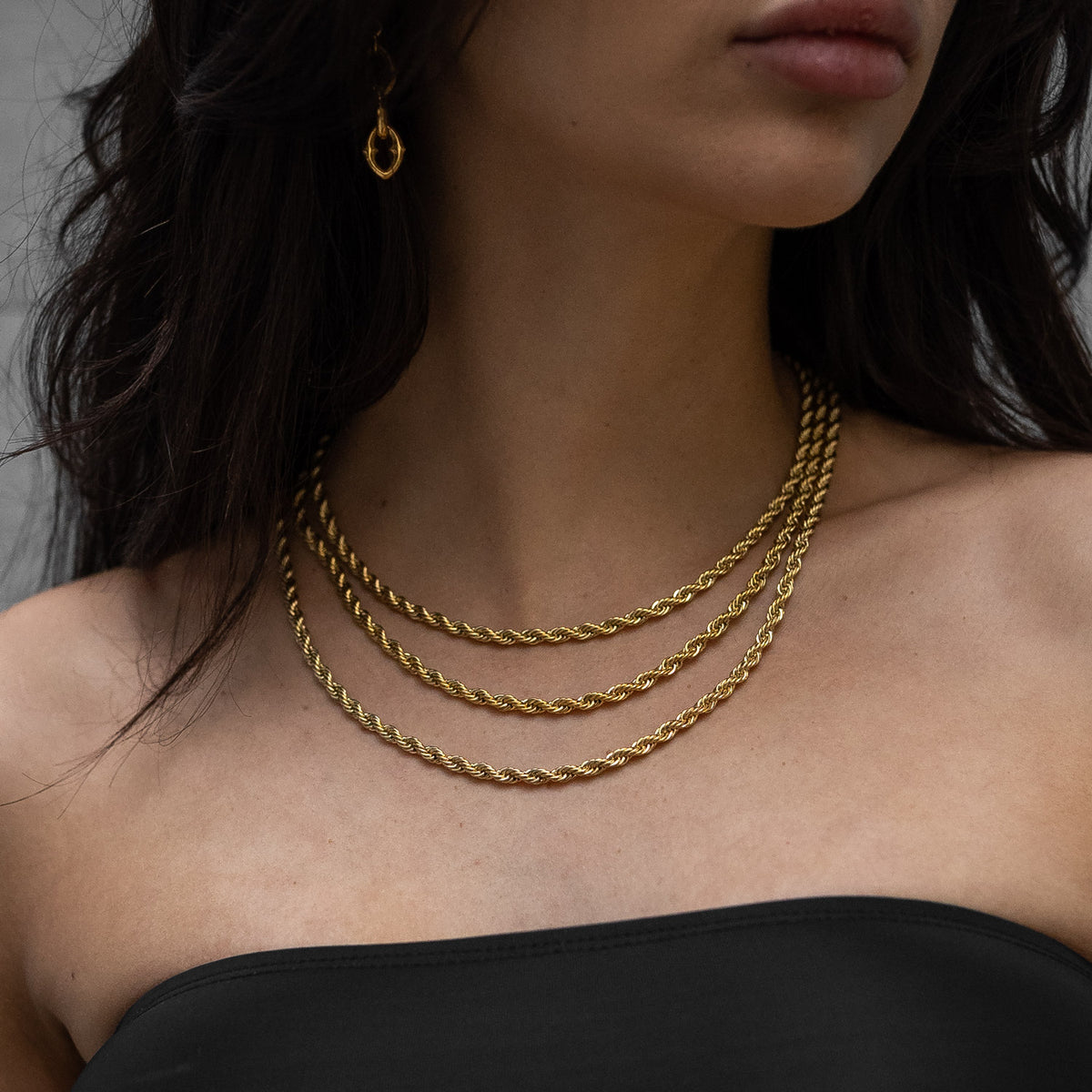 womens gold rope chain stack on body